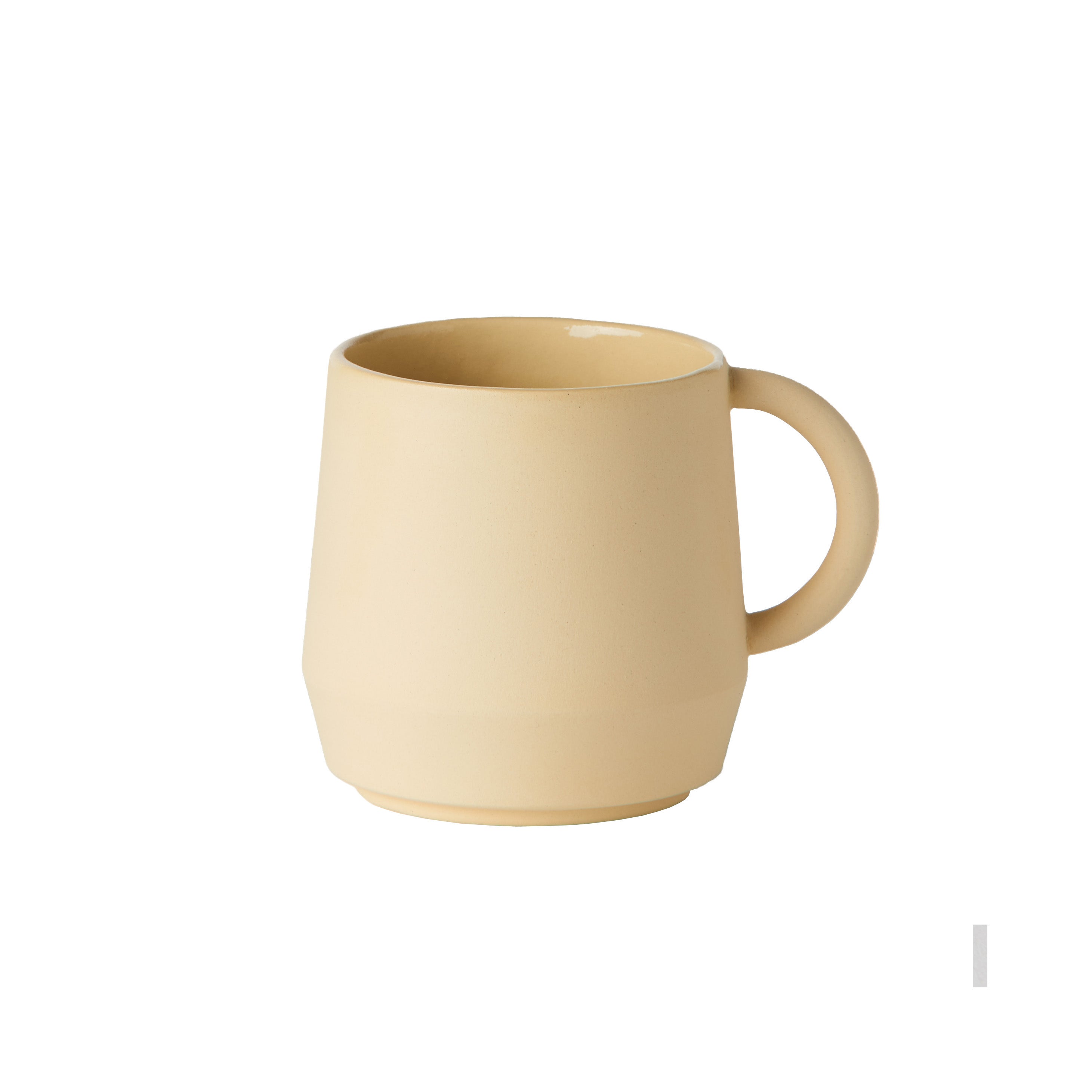 A handmade German Unison Cup by Schneid is placed against a white background. Its a plain beige ceramic mug featuring a round handle, smooth surface, and slightly tapered shape toward the base.