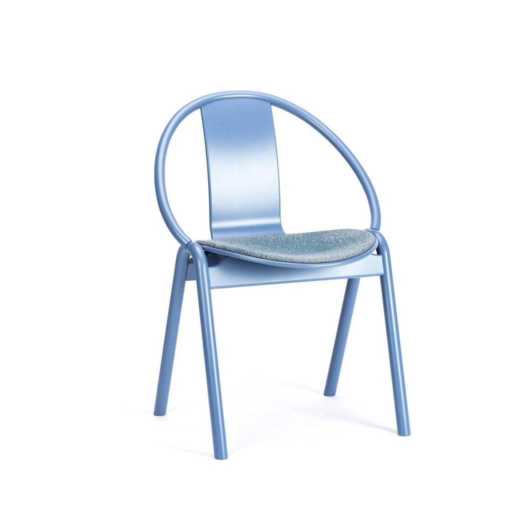 The Chair Again Upholstered by TON is a modern blue chair featuring a curved backrest and four straight solid beech wood legs. Its round, cushioned seat is covered in soft, textured fabric. The minimalist design blends contemporary style with classic bentwood influences.