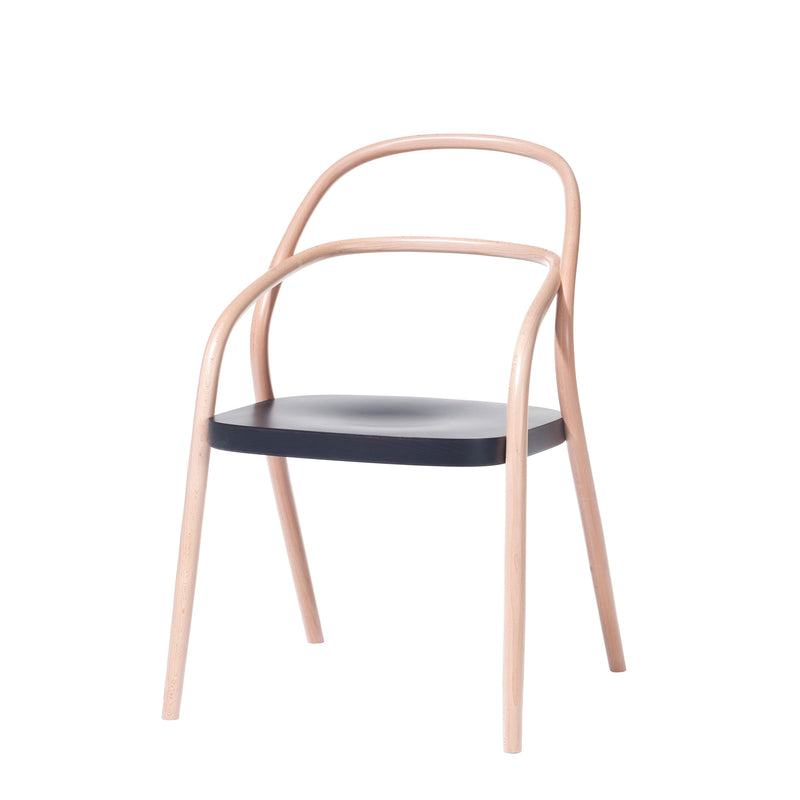 Chair 002 by TON features a wooden frame with a curved backrest and armrests. Its light brown finish complements the solid black seat, combining minimalist elegance with classic design.