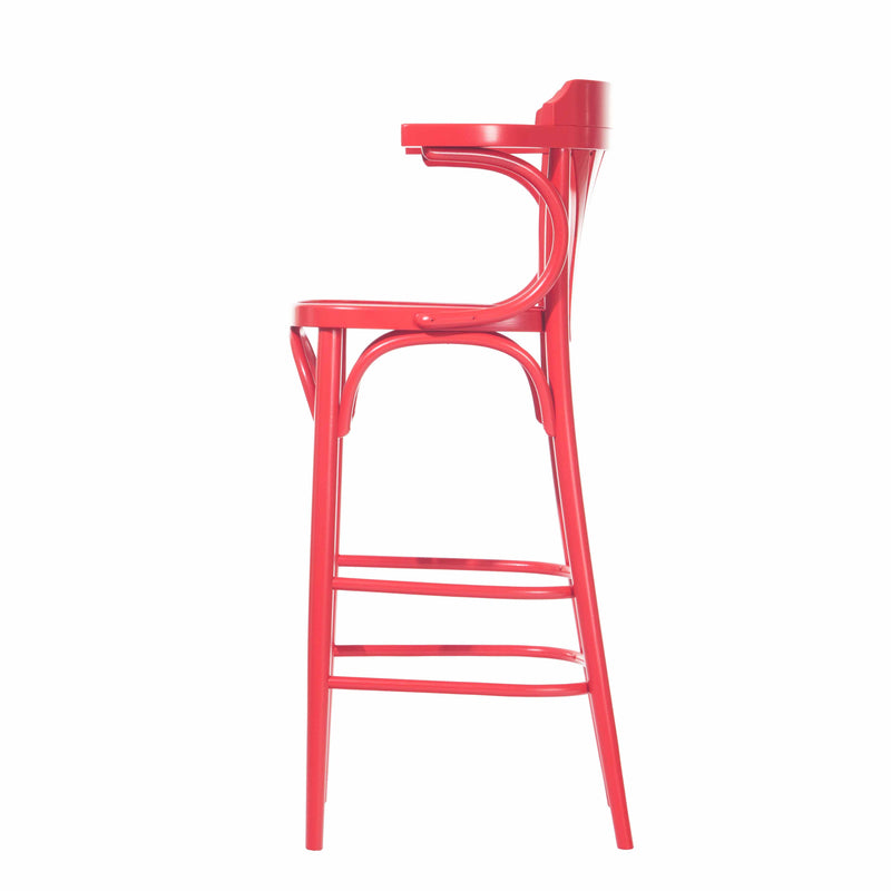The Barstool 135 by TON, shown in profile, features a vibrant red curved backrest and arched support. Made from sleek plywood, it has four slender legs with a footrest. The clean white background highlights its elegant simplicity and color.