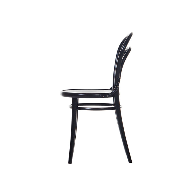 A side view of Chair 14 by TON showcases a sleek black design, reminiscent of classic café chairs. Its curved backrest, bent beech rods, four straight legs, and round seat against a white background epitomize the timeless design ethos of TON Since 1859.