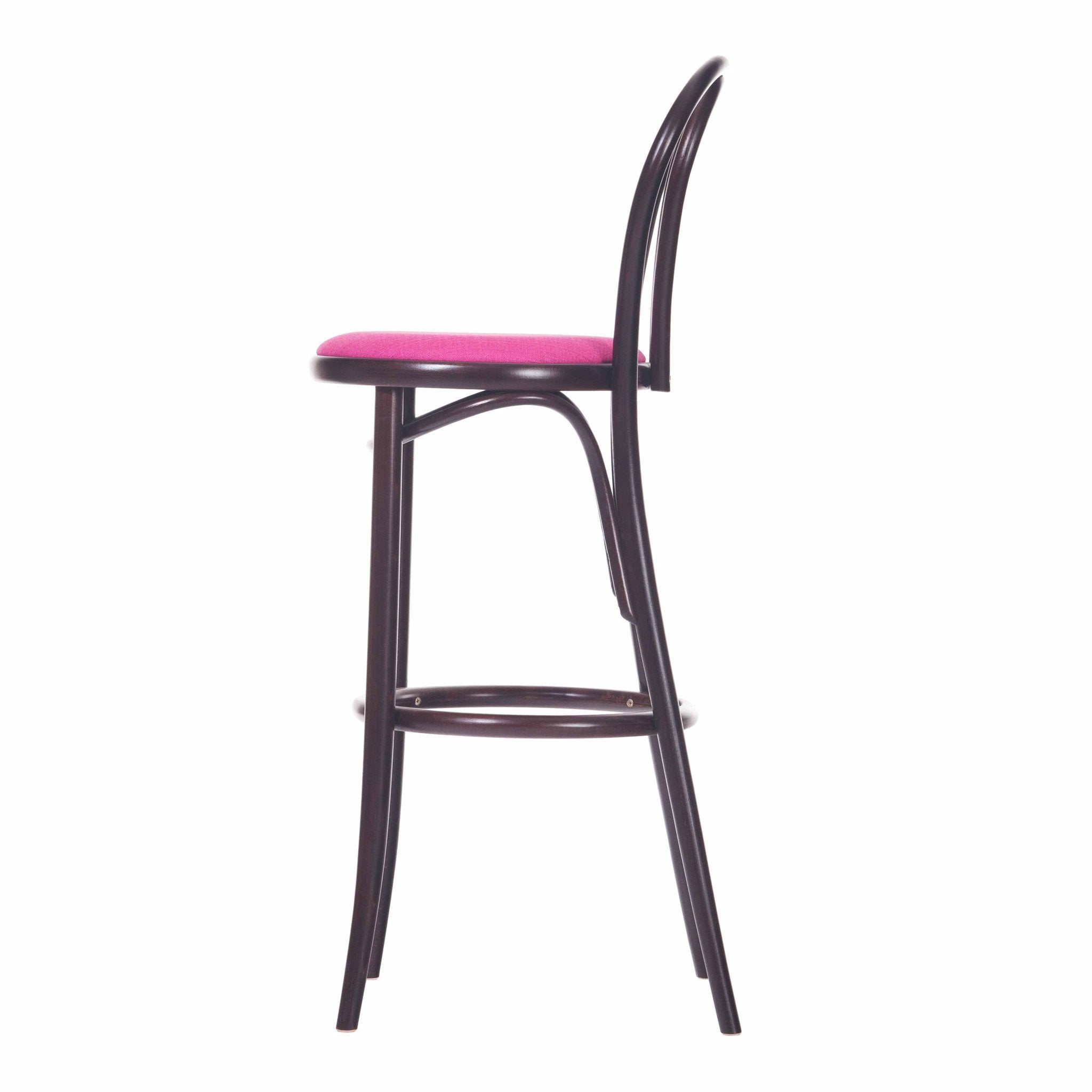 The Barstool 18 by TON is a side-view, tall, dark wooden barstool featuring a pink upholstered seat. It has a curved backrest with vertical supports and includes a footrest on its legs, offering a simple, modern plywood design.