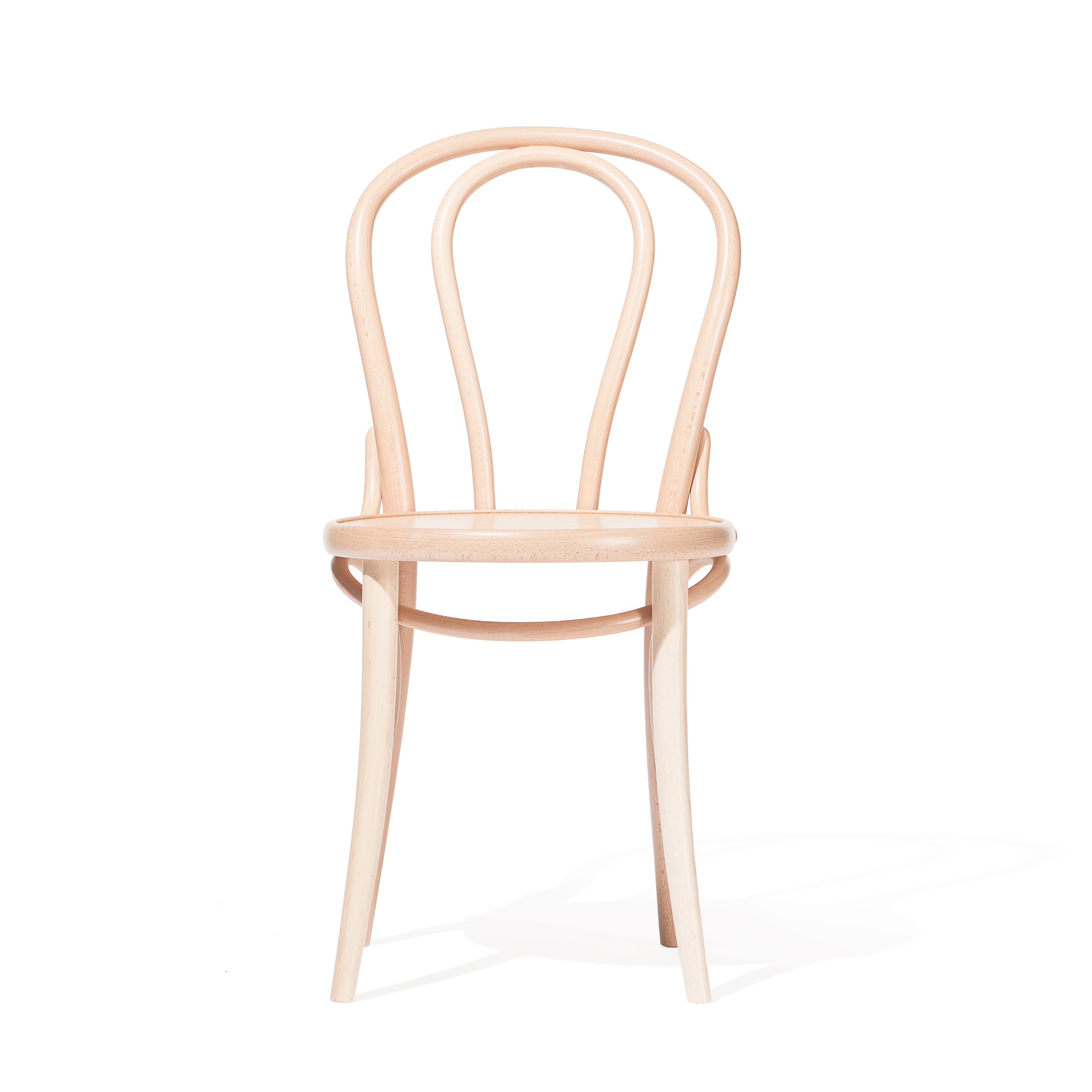 The Chair 18 - Upholstered by TON is a classic beech wood dining chair with a manually bent rod for the curved backrest and a circular seat. Set on a plain white background, it showcases a simple, elegant design and natural wood finish.
