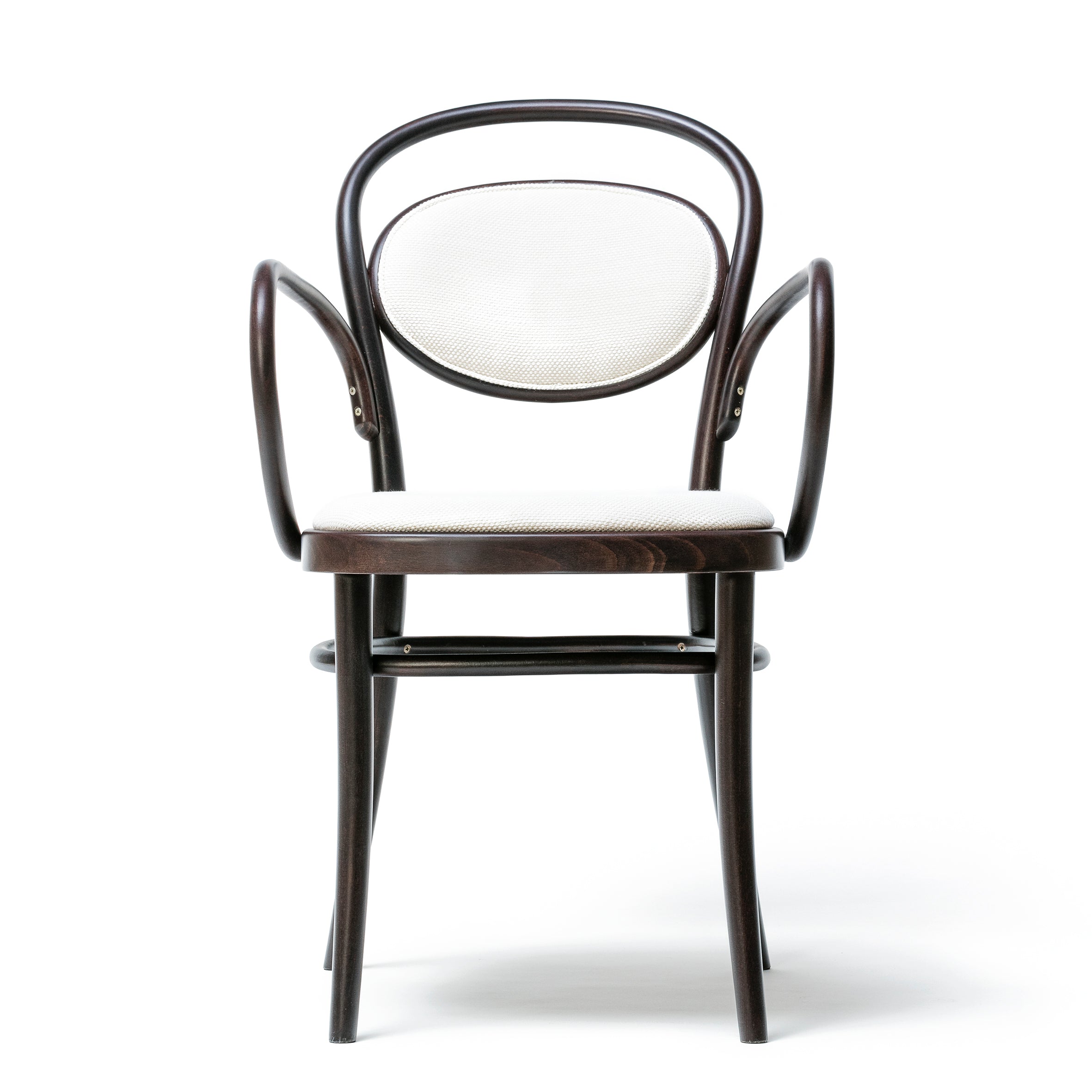 The Armchair 20 by TON features a dark wooden frame with elegantly curved armrests, a circular, cushioned backrest, and an upholstered seat in white fabric. It boasts beech finishes and is set against a plain white background.