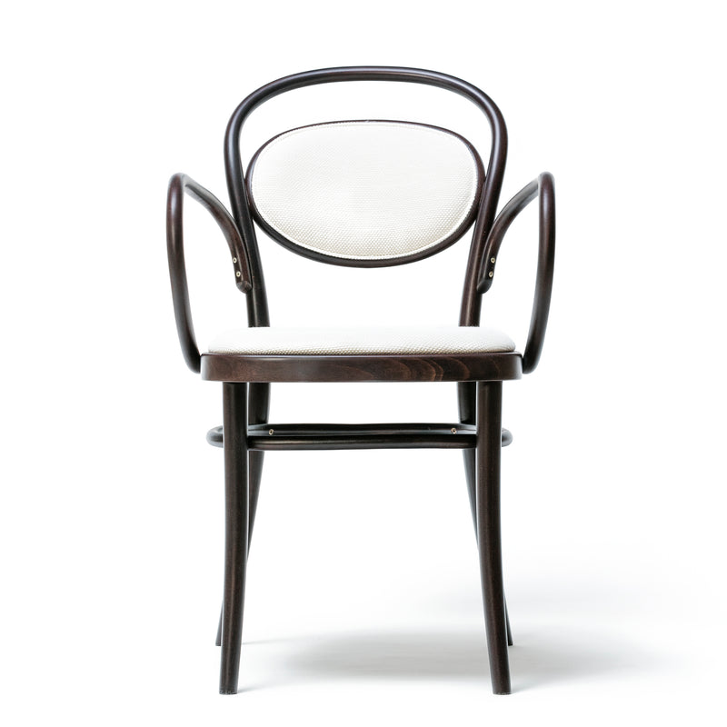 The Armchair 20 by TON features a dark wooden frame with elegantly curved armrests, a circular, cushioned backrest, and an upholstered seat in white fabric. It boasts beech finishes and is set against a plain white background.