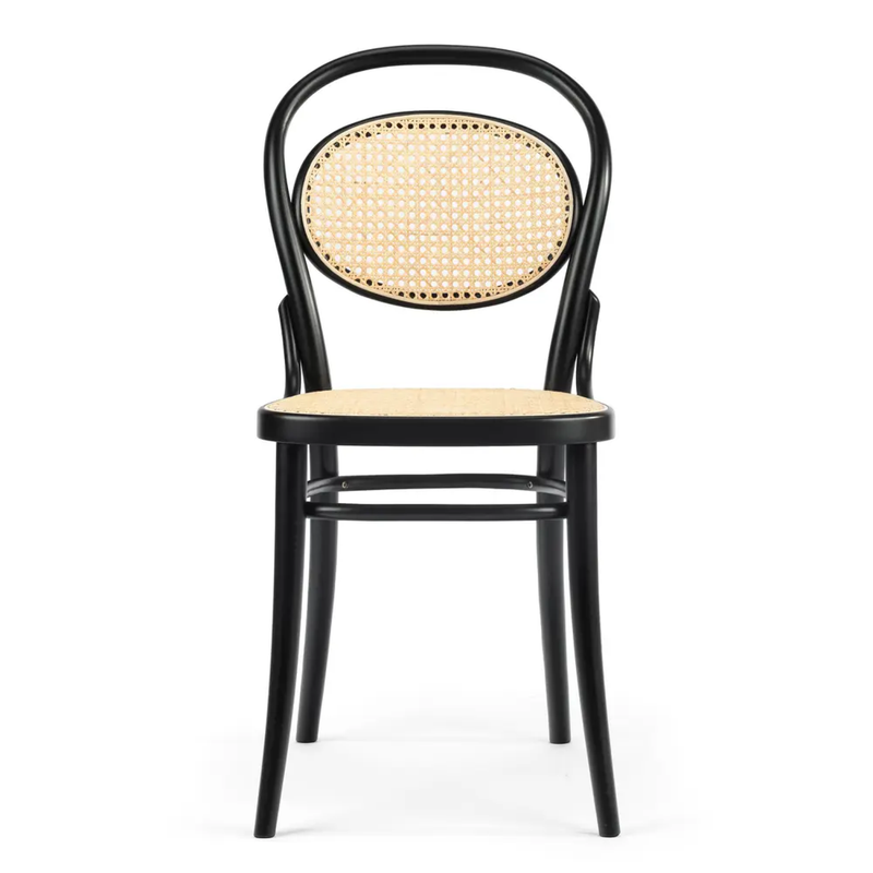 The Chair 20 Cane-Sale by TON features a classic black wooden design, curved backrest, and elegant cane seating. Its vintage look is enhanced by a durable beech frame with sturdy four straight legs.