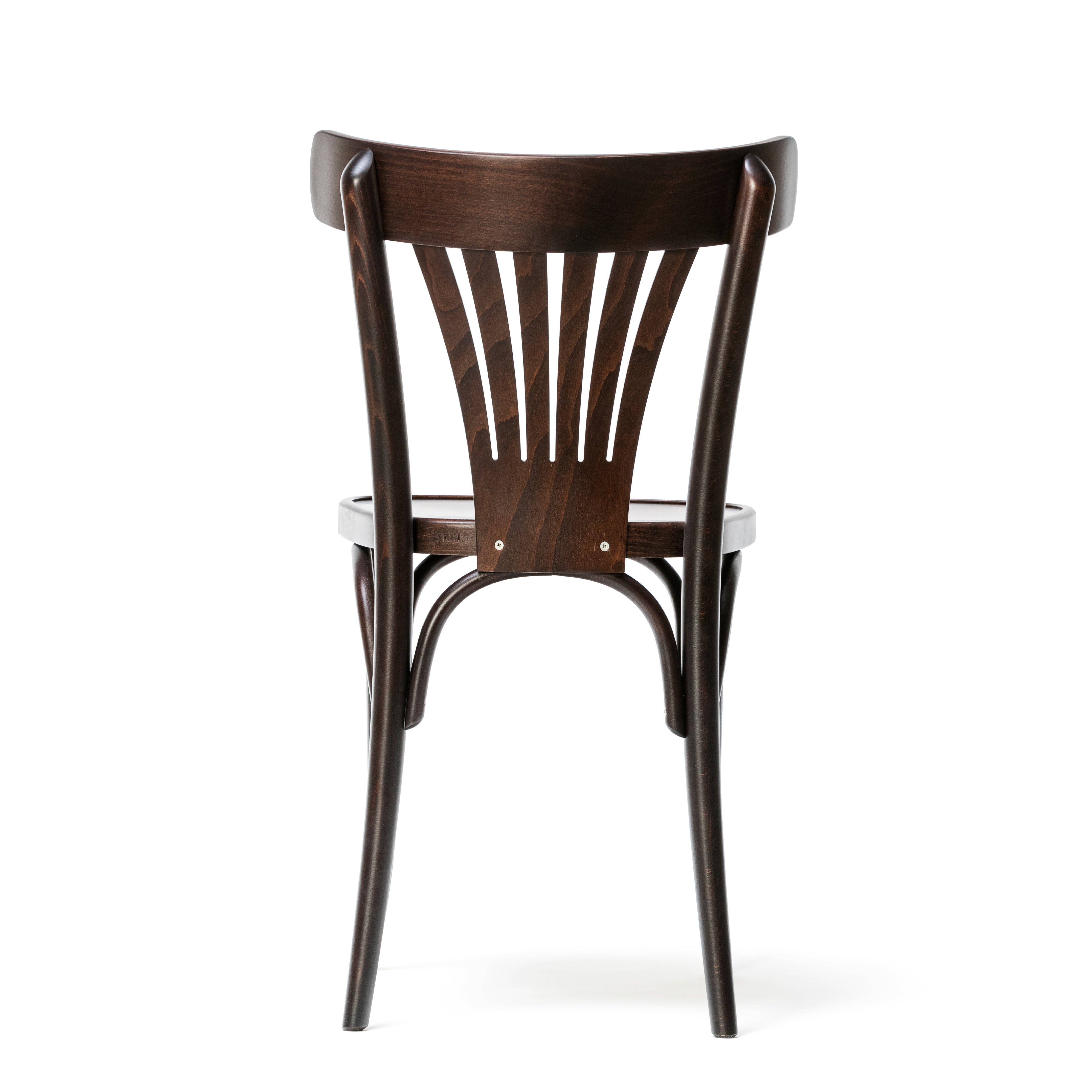 The Chair 56 by TON features a dark finish, elegantly angled legs, and a curved slatted backrest, offering a stylish view from behind.