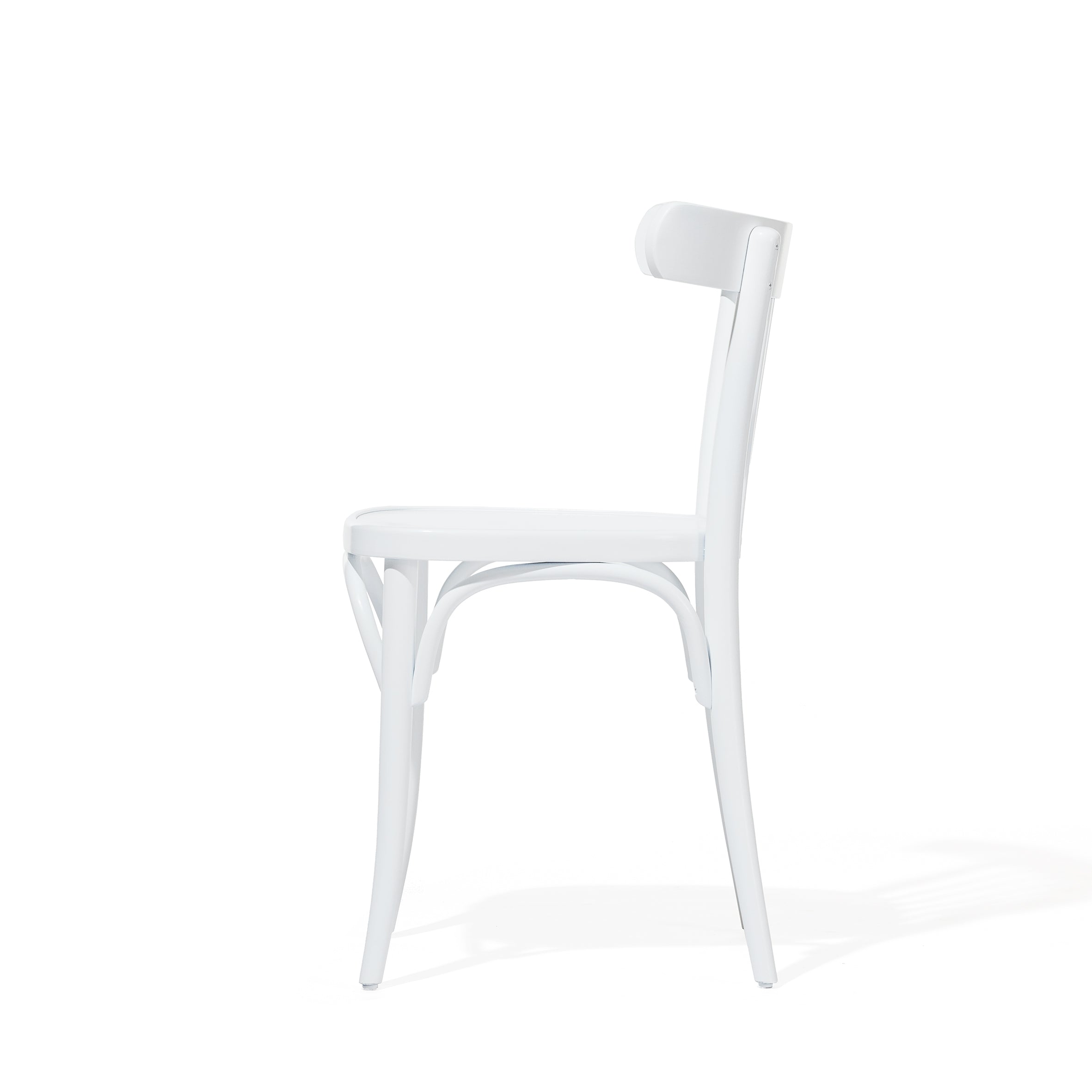 Side view of the Chair 763 by TON, made from beech wood with a curved backrest and legs, on a plain white background. It casts a subtle shadow, ideal for modern interiors.