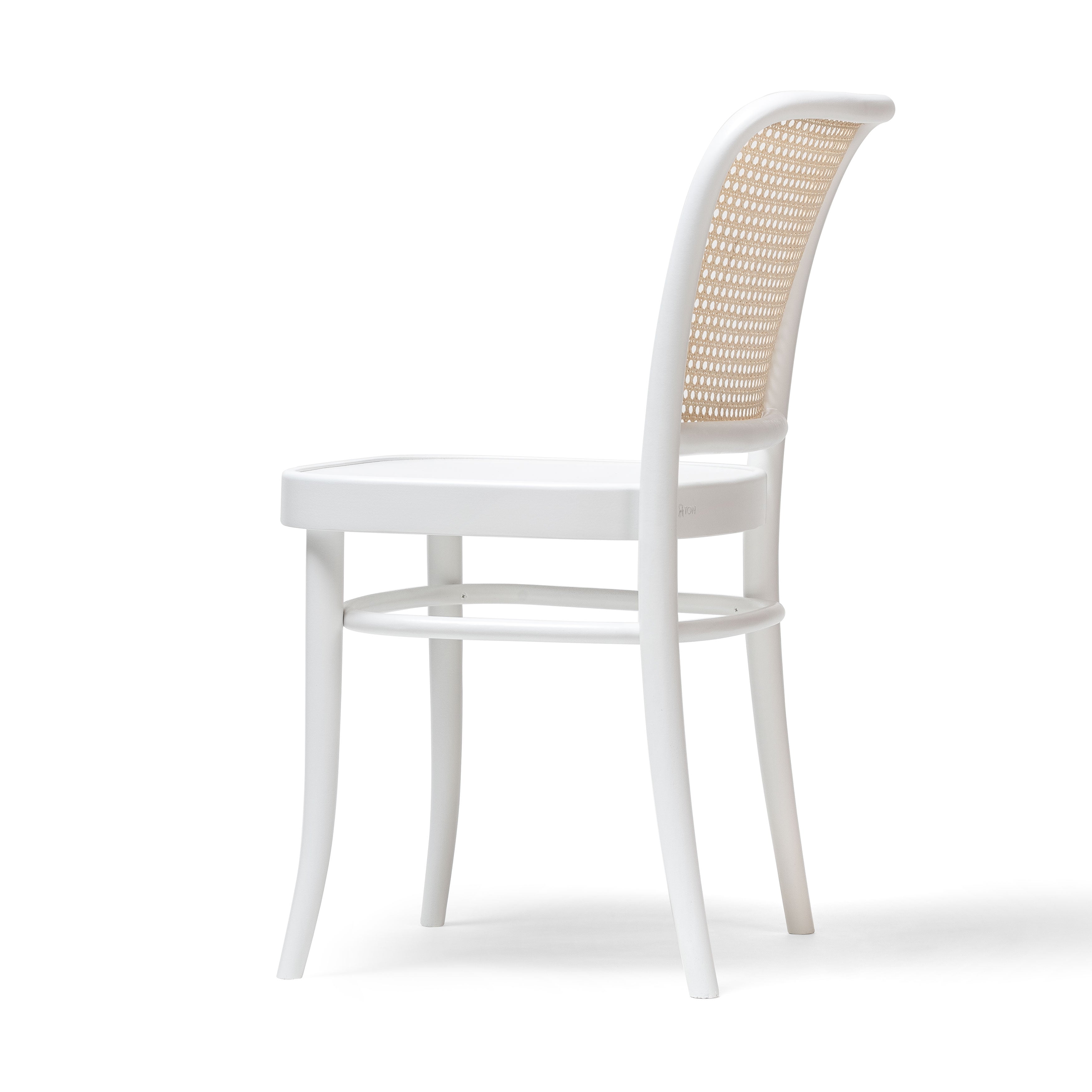 The Chair 811 by TON features a white frame with a curved backrest showcasing an exquisite woven cane design. Its slim, slightly tapered legs add elegance and minimalism, reminiscent of the classic Josef Hoffmann chair, all set against a plain white background for captivating allure.