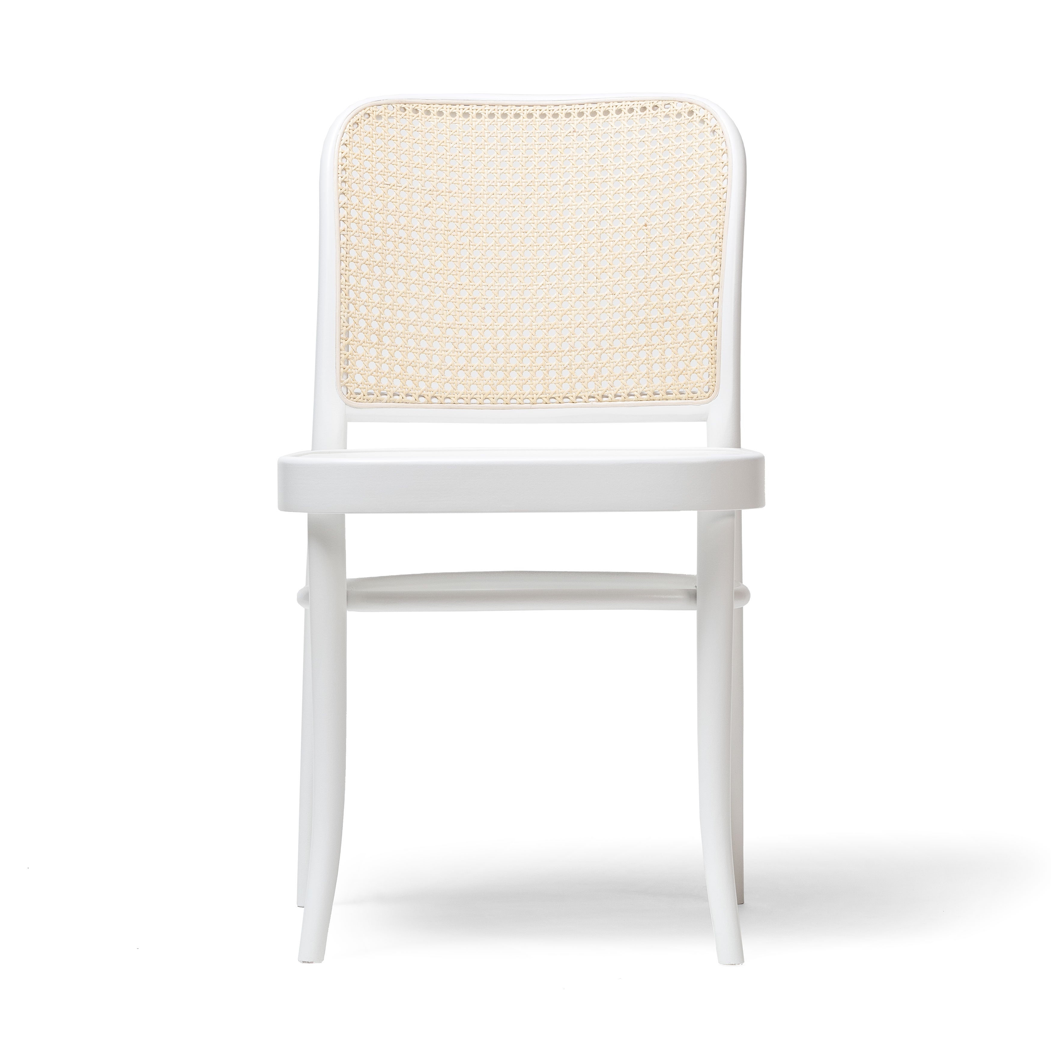 The Chair 811 by TON is a white wooden chair with a beige woven cane backrest, reminiscent of an Art Nouveau dining chair. Its minimalist design includes four straight legs and a solid seat, echoing Josef Hoffmanns style against a plain white background.