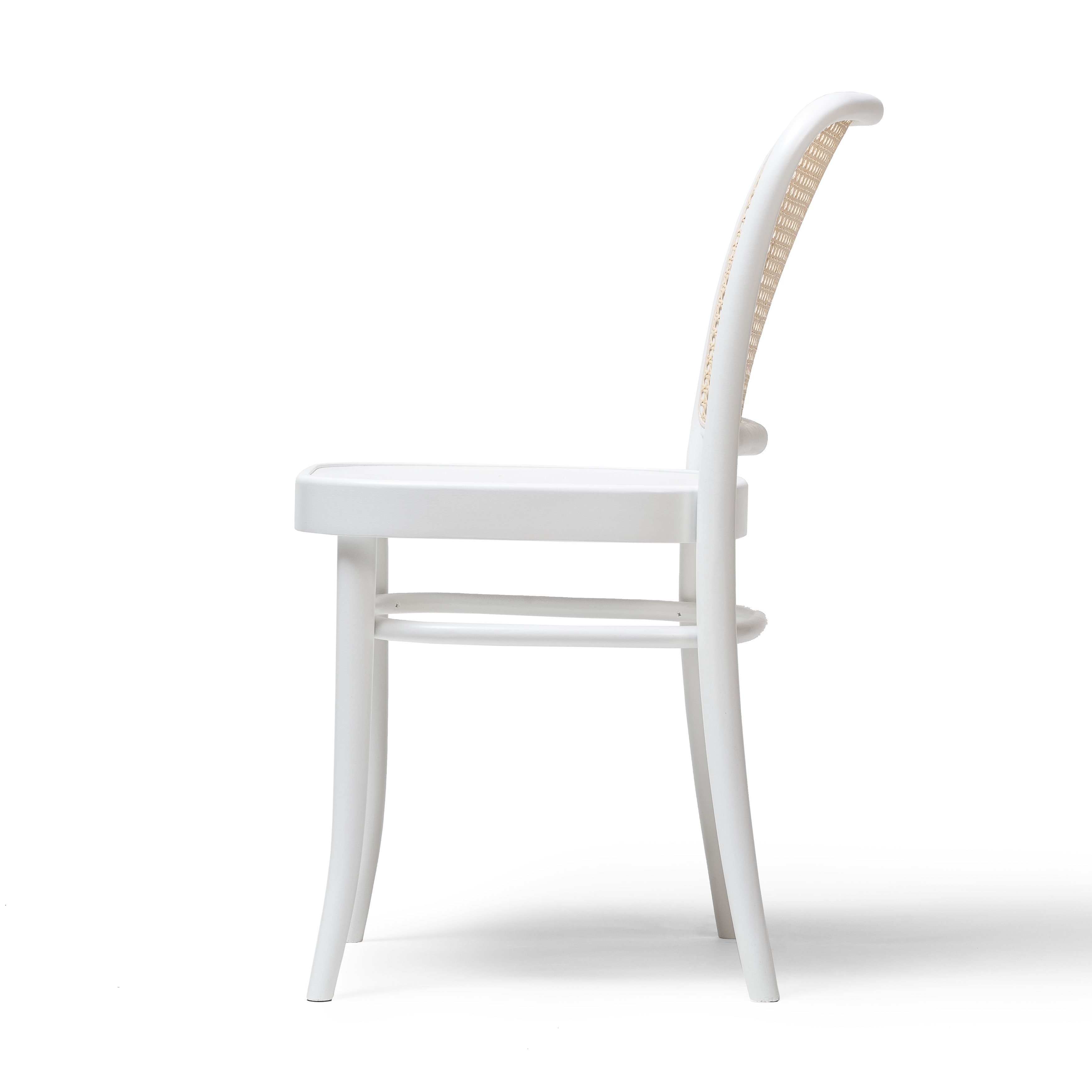 The Chair 811 by TON features a side view of a modern white design with a woven backrest, sleek curved legs, and a smooth surface. Reminiscent of an Art Nouveau dining chair, it showcases minimalist elegance.