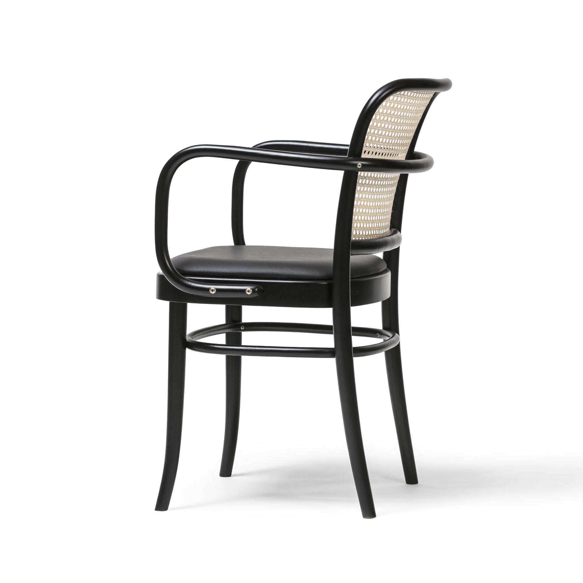 The Armchair 811 by TON features a sleek design with curved arms and legs, a rattan backrest, and a cushioned seat. Its black wooden frame exudes an Art Nouveau elegance, standing out against a plain white background and enhancing its modern allure.