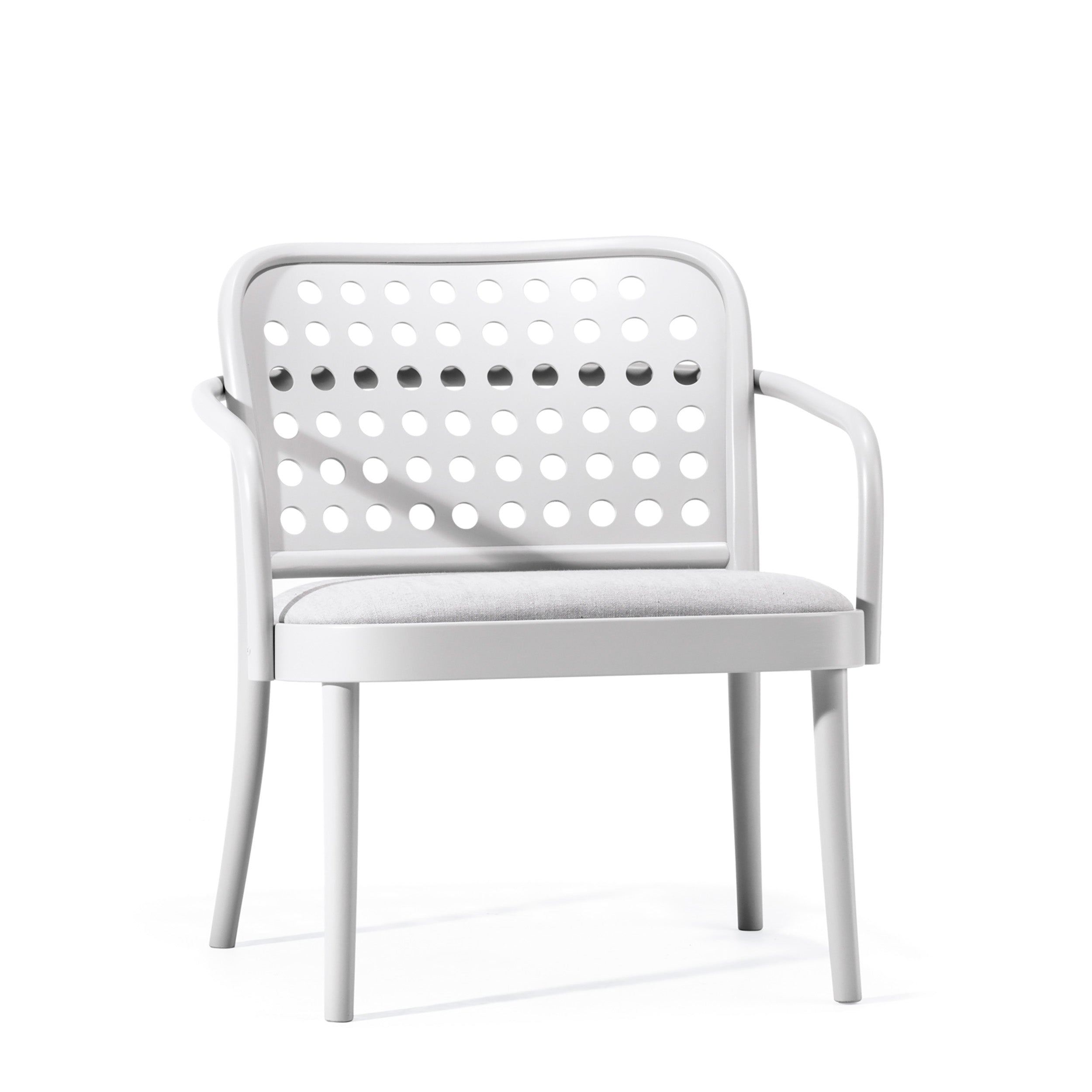The Lounge Armchair 822 by TON boasts Scandinavian minimalism with a white design, perforated circular backrest pattern, cushioned grey seat, and armrests. It elegantly stands on four legs against a plain white background.