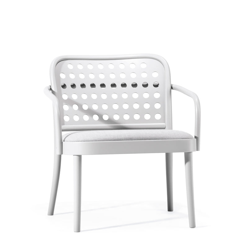 The Lounge Armchair 822 by TON boasts Scandinavian minimalism with a white design, perforated circular backrest pattern, cushioned grey seat, and armrests. It elegantly stands on four legs against a plain white background.