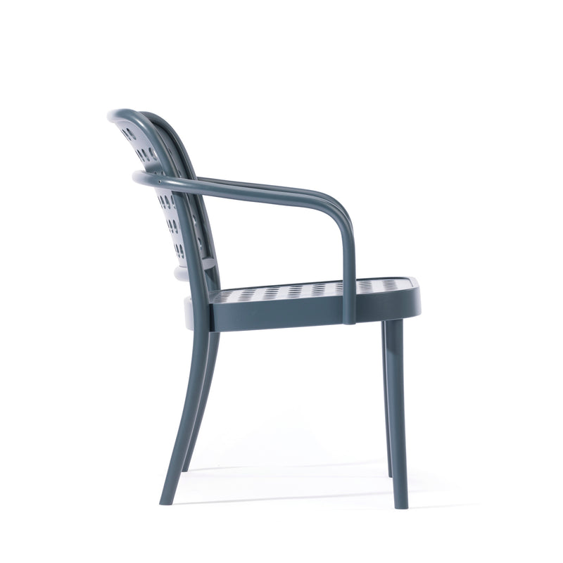 Side view of a grey Lounge Armchair 822 by TON, showcasing Scandinavian minimalism with a perforated backrest and seat. It features smoothly curved armrests on four slender legs reminiscent of Claesson Koivisto Runes aesthetic, set against a white background.