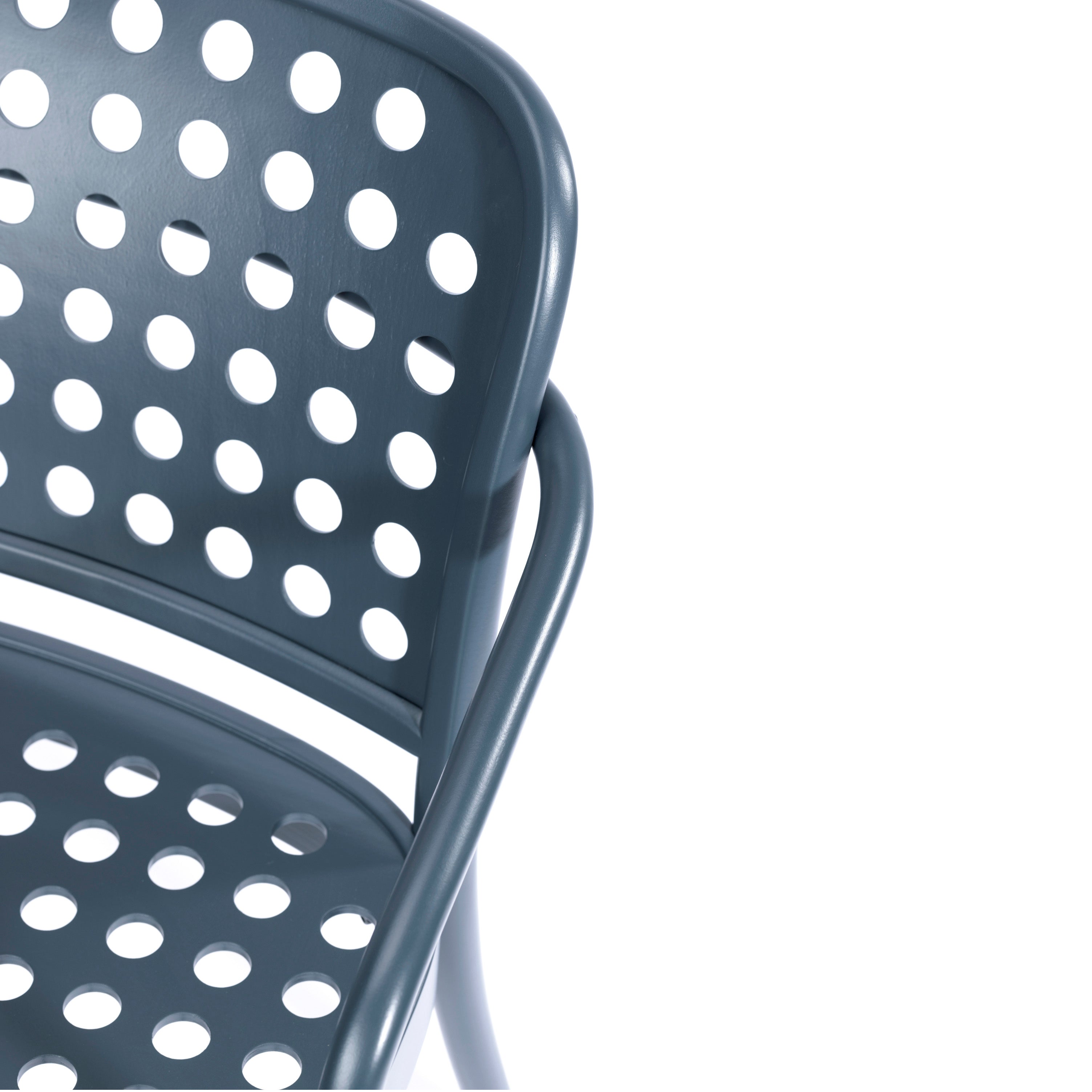 A close-up of the Lounge Armchair 822 by TON in dark gray metal showcases its Scandinavian minimalist design, with a perforated back and seat featuring evenly spaced circular holes, angled against a white background to evoke Claesson Koivisto Runes refined elegance.