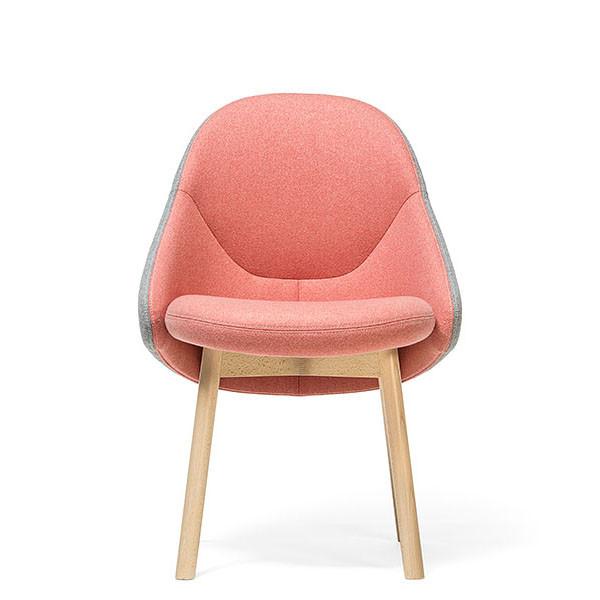 The Chair Albu by TON, designed by Alex Gufler, features a rounded pink cushioned seat with pocket springs and backrest. It has light wooden legs and is wrapped in light gray fabric on the outer edges, offering a stylish contemporary appeal.