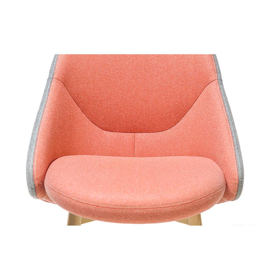 The Chair Albu by TON, designed by Alex Gufler, features a smooth orange-pink seat and backrest with light gray fabric accents. Pocket springs enhance comfort, and wooden legs add to its minimalist aesthetic.