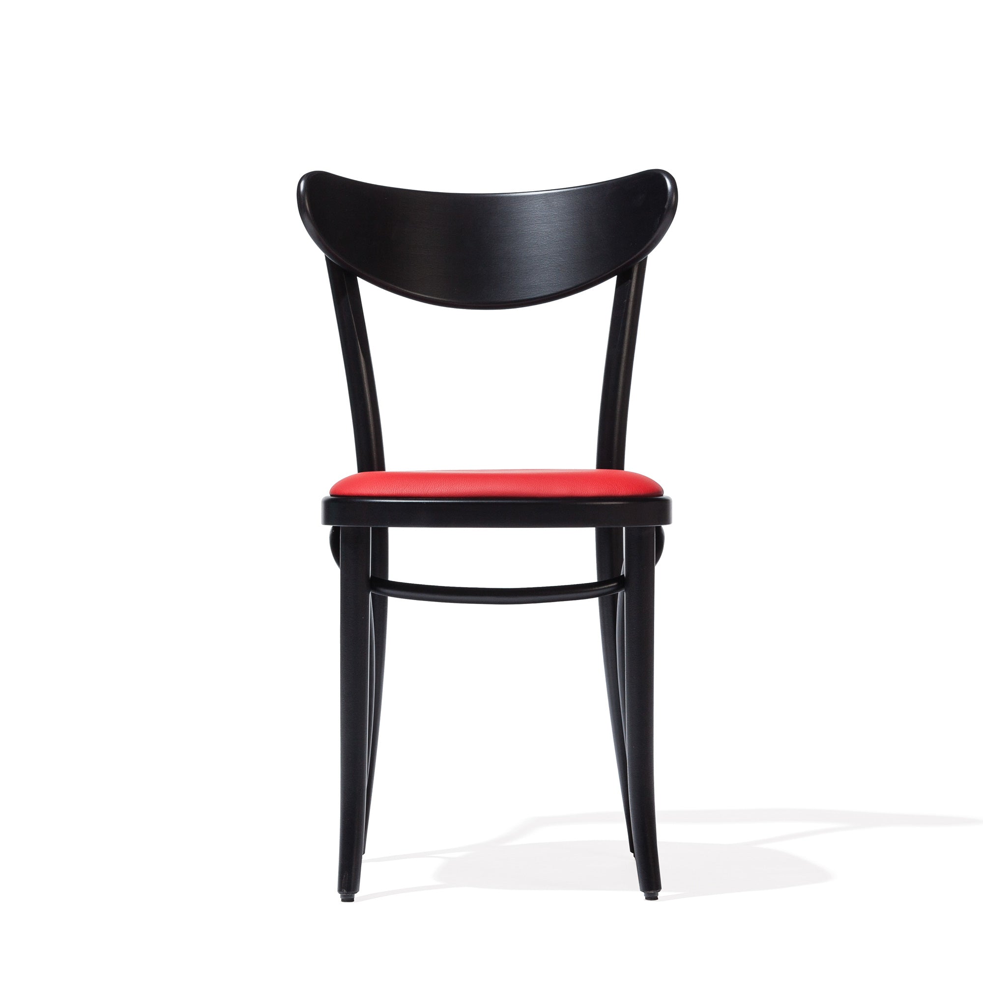 The Chair Banana by TON is a modern black bentwood chair with a plywood backrest and vibrant red upholstered seat, showcased against a plain white background.