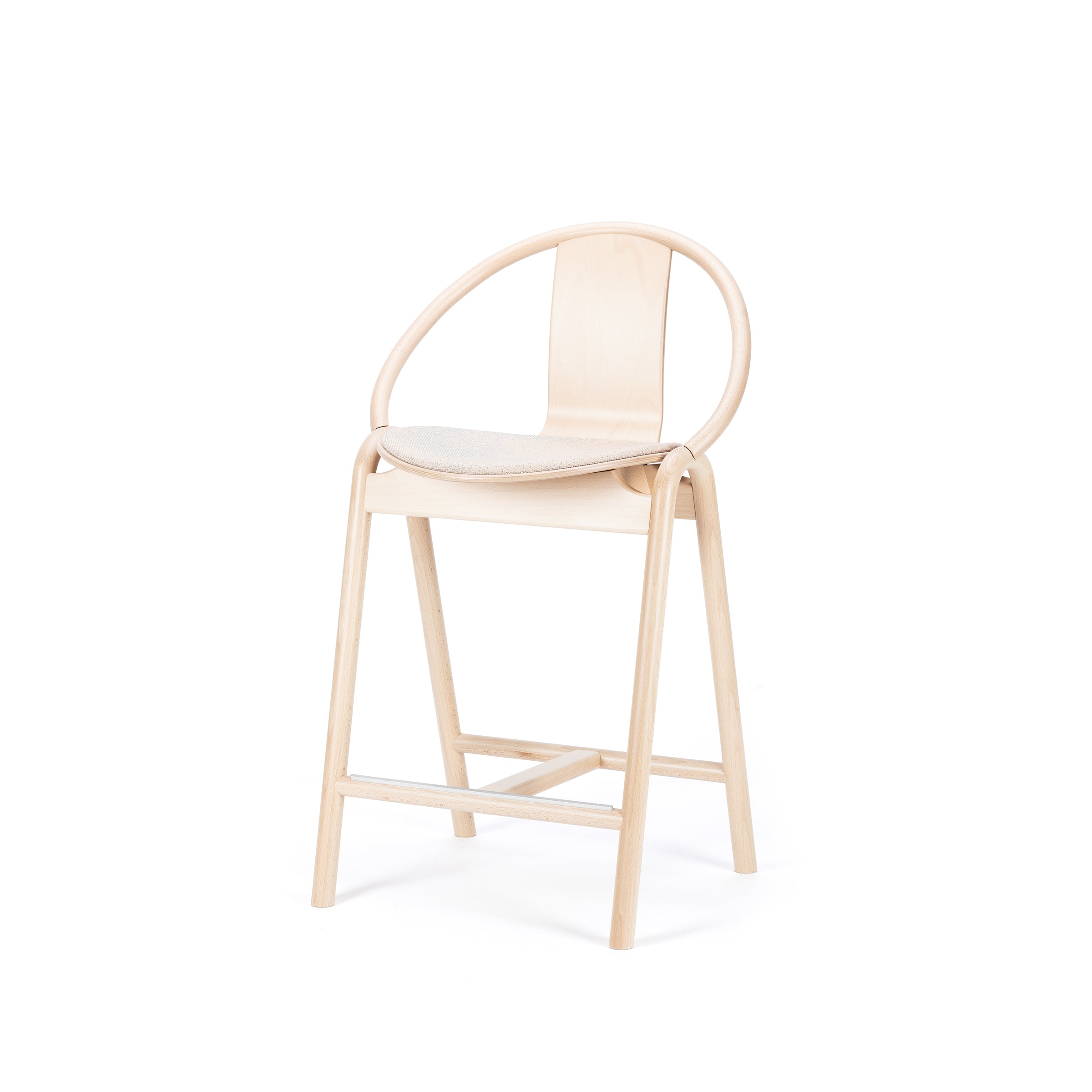 The Barstool Again Upholstered by TON showcases a sleek, modern design with a light wood finish, circular backrest, and clean lines. It features a simple upholstered seat cushion in a neutral color and includes a convenient footrest, making it ideal for any contemporary space.