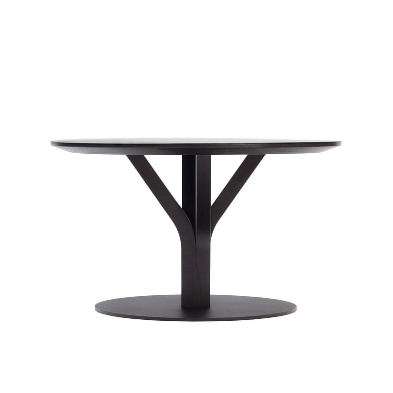 The Bloom Coffee Table by TON is a modern round piece crafted from solid wood, featuring a flat tabletop with a sleek Y-shaped central support connecting to its circular base. Its minimalist design emphasizes clean lines and symmetry.