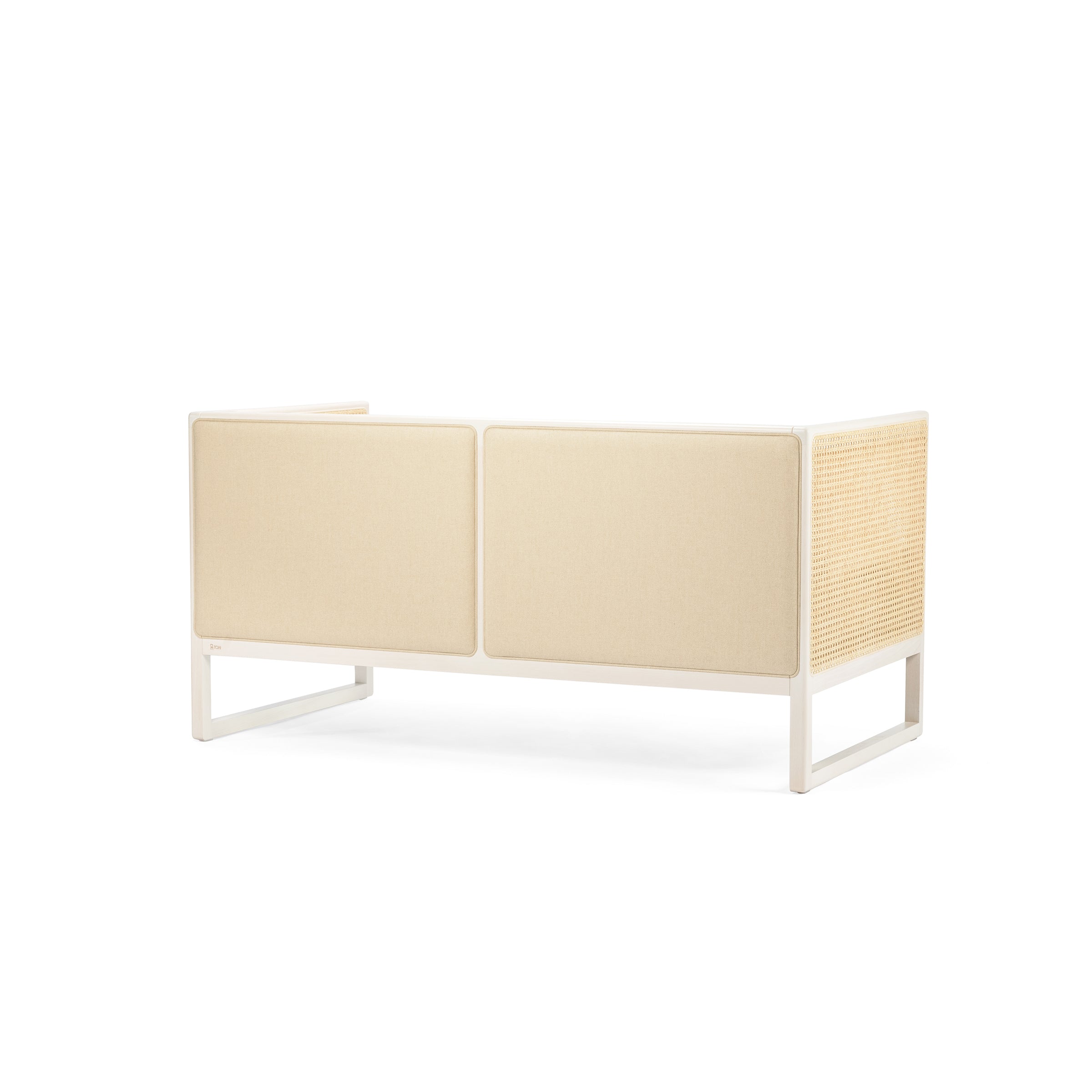 The Casablanca Sofa by TON features a minimalist design with two large fabric panels and woven textures resembling cane weave armrests, all in beige. It has a clean rectangular form with a white frame and an open base, echoing the essence of modern lounge furniture.