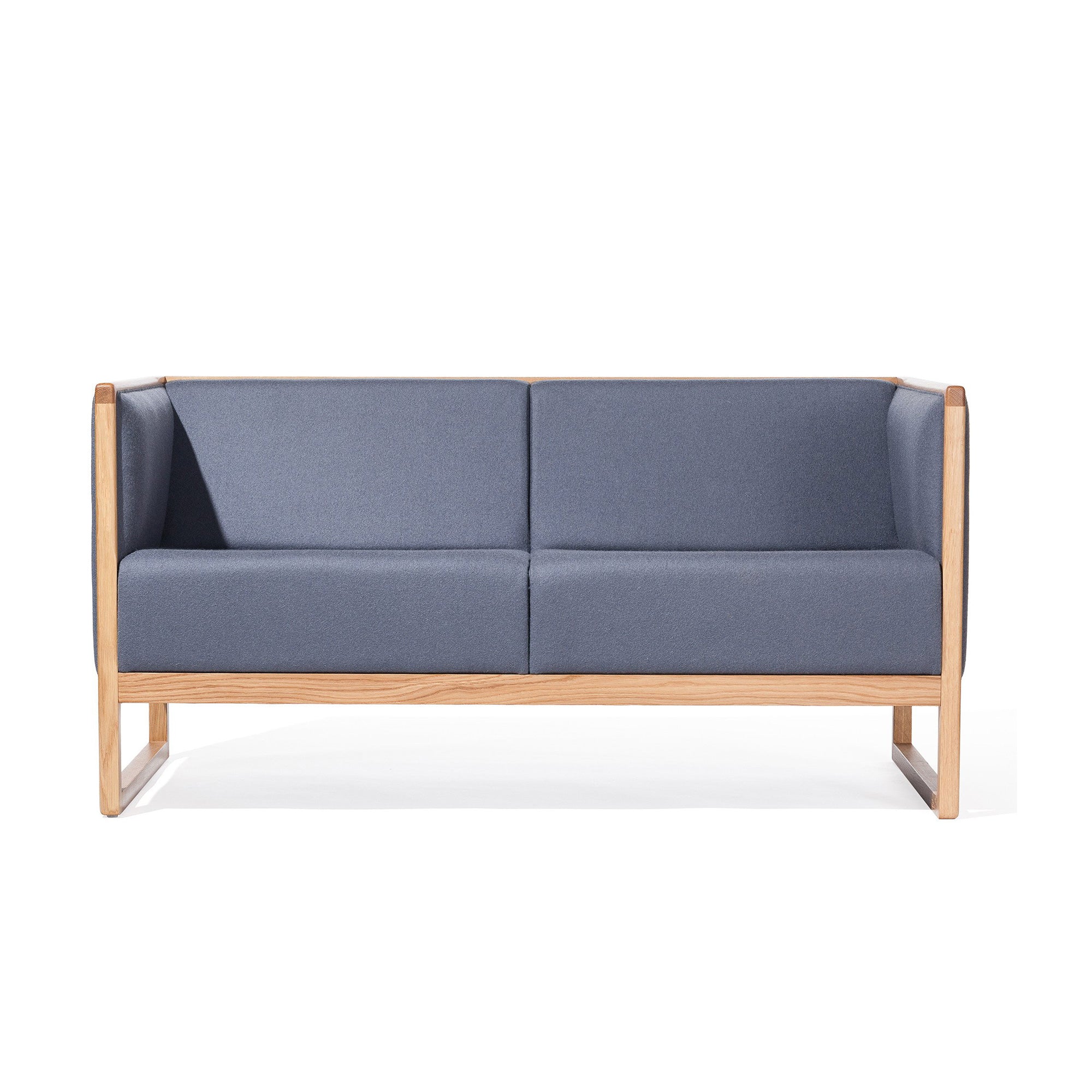 The TON Casablanca Sofa is a modern two-seater with a minimalist design featuring straight lines, a light wooden frame, blue cushions, and cane weave armrests. Set against a white background, it embodies contemporary elegance.