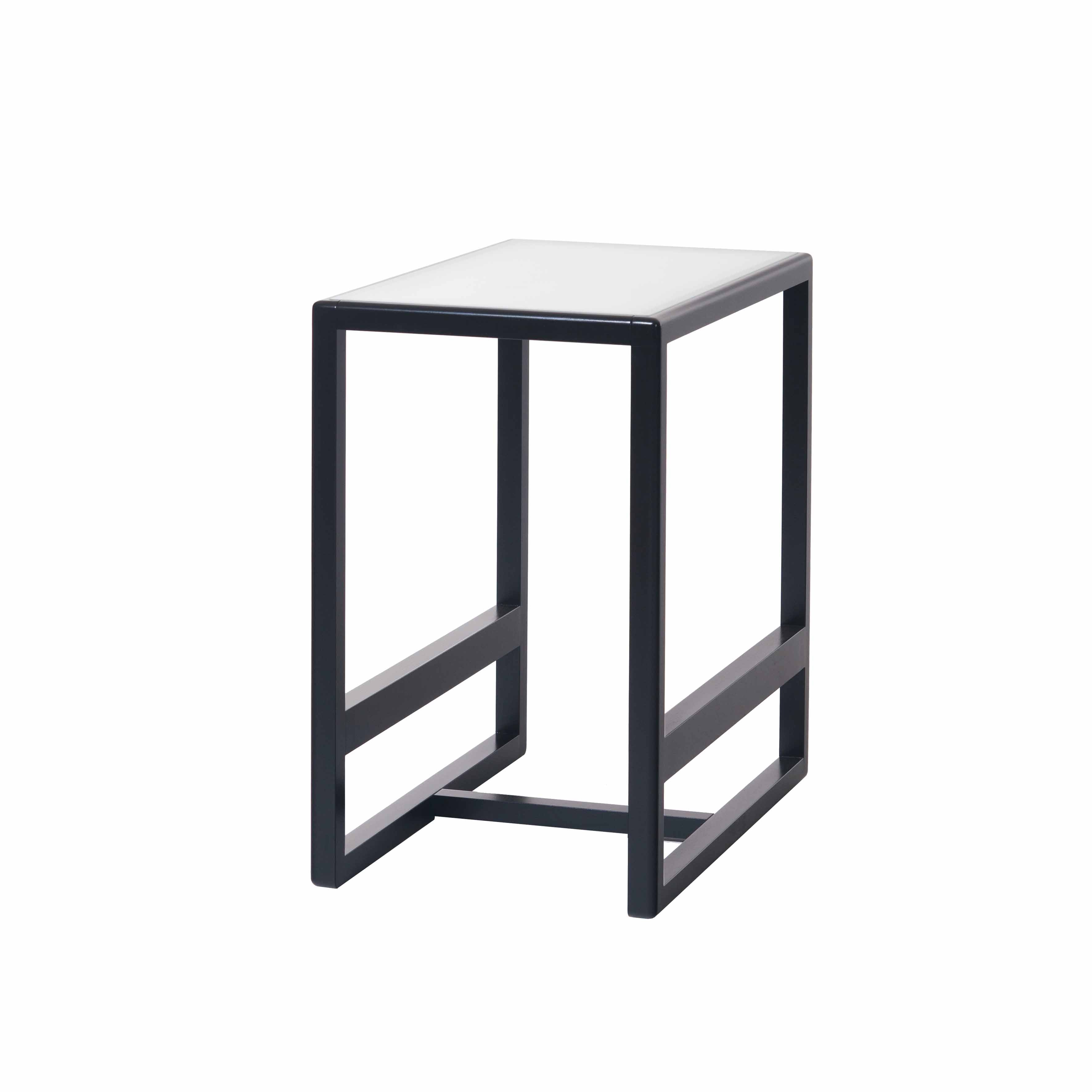 The Side Table Casablanca by TON is a minimalist rectangular table featuring a white veneer top with a black metal frame, straight lines, and an open bottom.