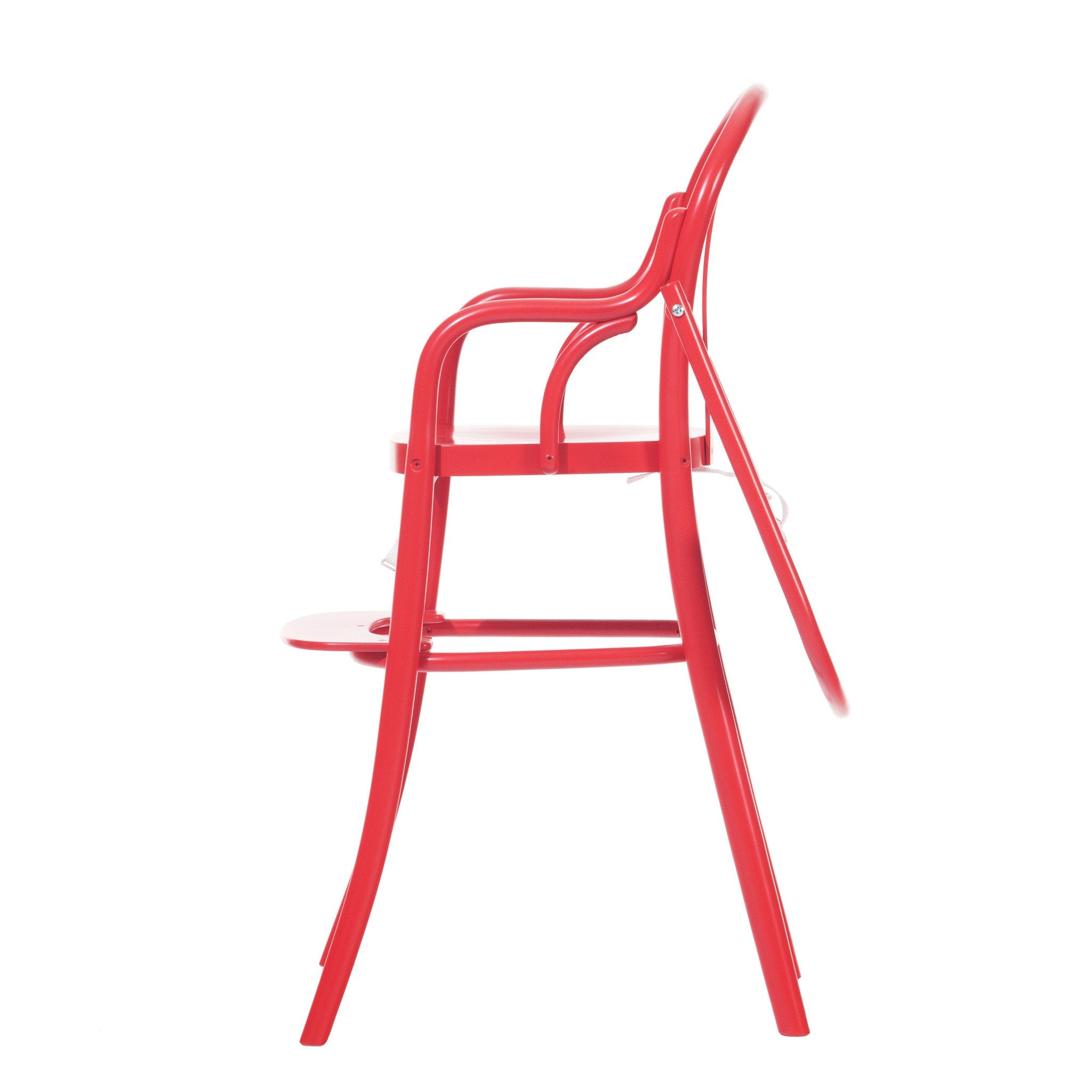 Side view of the Childrens Chair Petit 114 by TON, a modern red folding chair with a sleek, minimalist design. Reminiscent of childrens furniture, it features a smooth finish and curved lines. Metal rods connect the seat and backrest for style and safety.