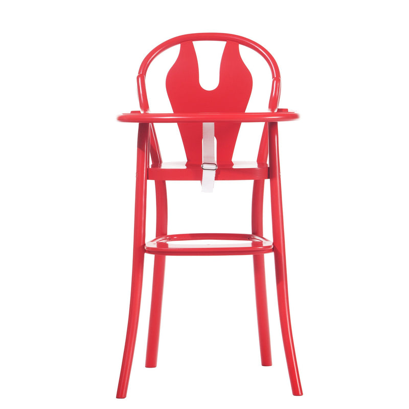 The Childrens Chair Petit 114 by TON is a modern red high chair that blends seamlessly into any childrens furniture collection with its sleek, minimalist design. It features a curved backrest, safety belt, and sturdy legs, combining functionality with contemporary aesthetics for small children.