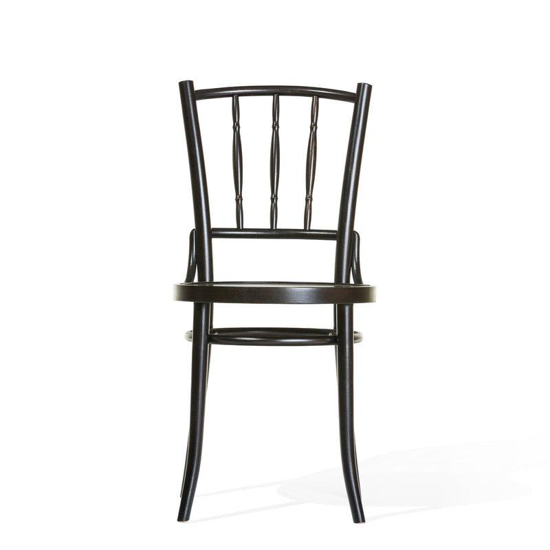 The Chair Dejavu 378 by TON is a classic dining chair made from bent beech wood. It features a curved backrest, vertical slats, and an arched support beneath its seat, all painted in rich dark brown. Set against a plain white background, it showcases an elegant design.