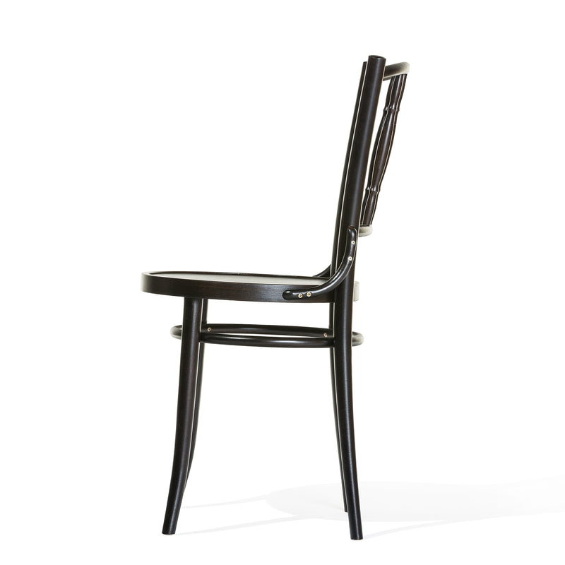 Side view of the TON Chair Dejavu 378 - Cane, crafted from bent beechwood with a curved backrest and four slender legs, highlighting its strength and stability against a plain white background.