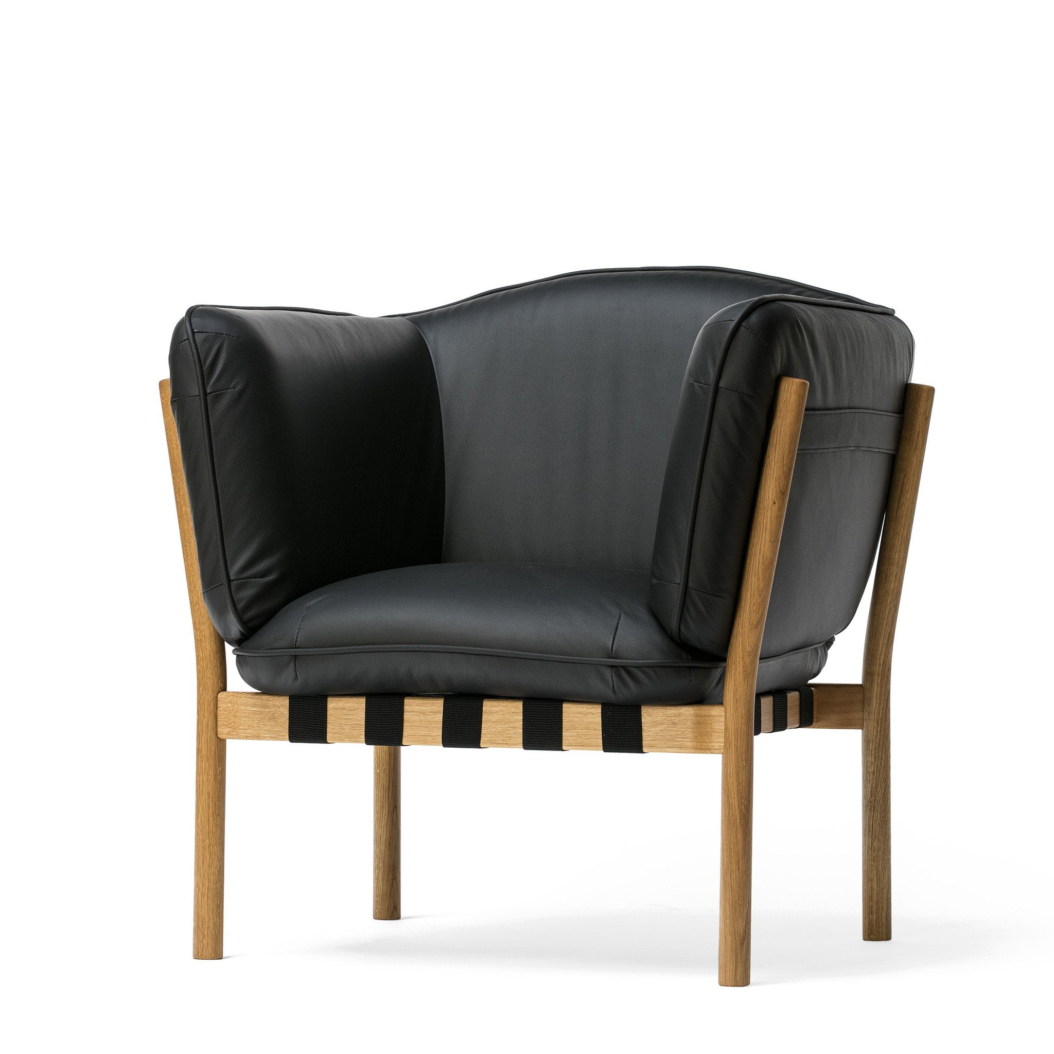The Dowel Lounge Chair by TON blends modern elegance with comfort through its thickly padded black leather upholstery. Its minimalist design features a light wooden frame and visible black webbing below the seat, making it a standout piece in any interior.