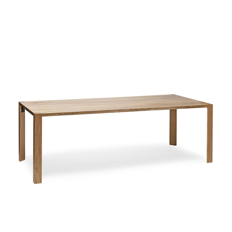 The Table Ink by TON is a minimalist, rectangular wooden table with a natural finish and thin tabletop. It features four triangular legs for a clean, modern aesthetic against a plain white background.