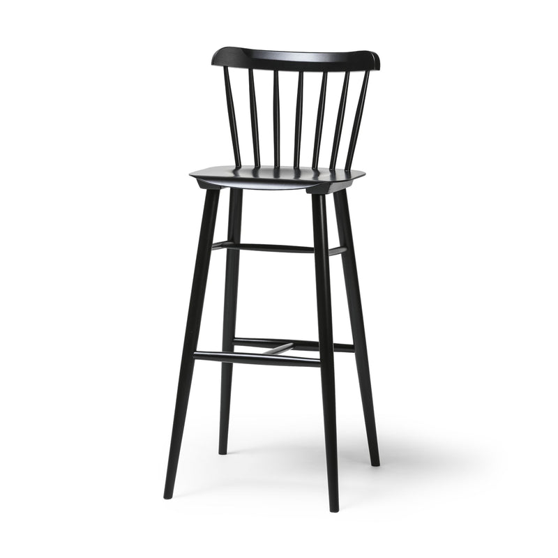 Introducing the TON Barstool Ironica—a minimalist, black beech and oak barstool with a high backrest featuring vertical slats, four tapered legs, a footrest between the front legs, and hand-finished dowels for an elegant touch.