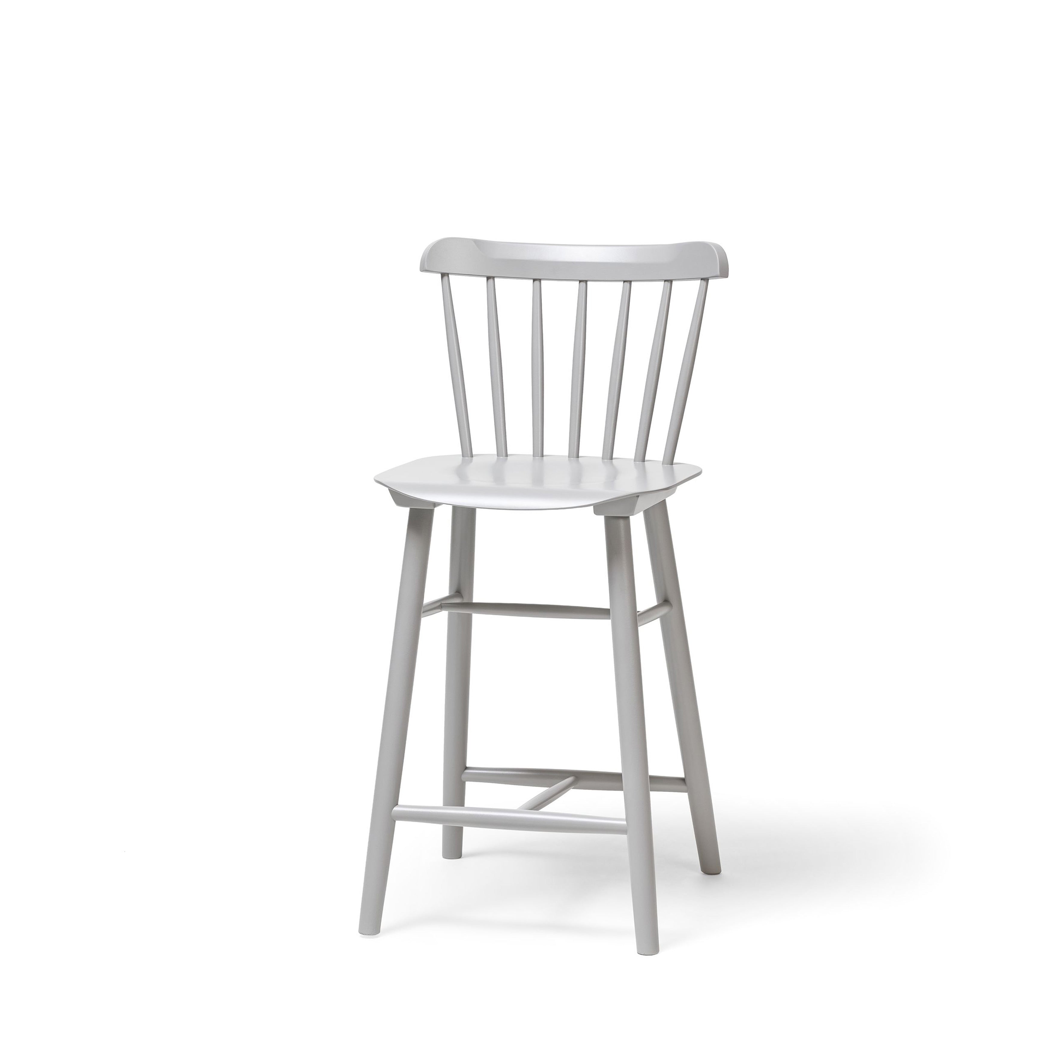 The TON Barstool Ironica is a white beech and oak chair featuring a straightforward design with vertical slats on its rounded backrest, a slightly curved seat, and four straight legs with horizontal supports, set against a plain white background.