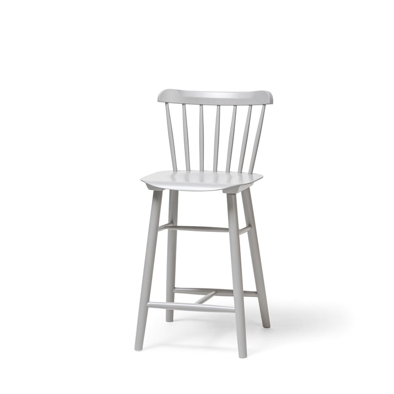 The Counter Stool Ironica by TON is crafted from beech oak, showcasing a white finish. It features a high backrest with a slatted design, a square seat, and four legs connected by hand-finished dowels against a plain white background.
