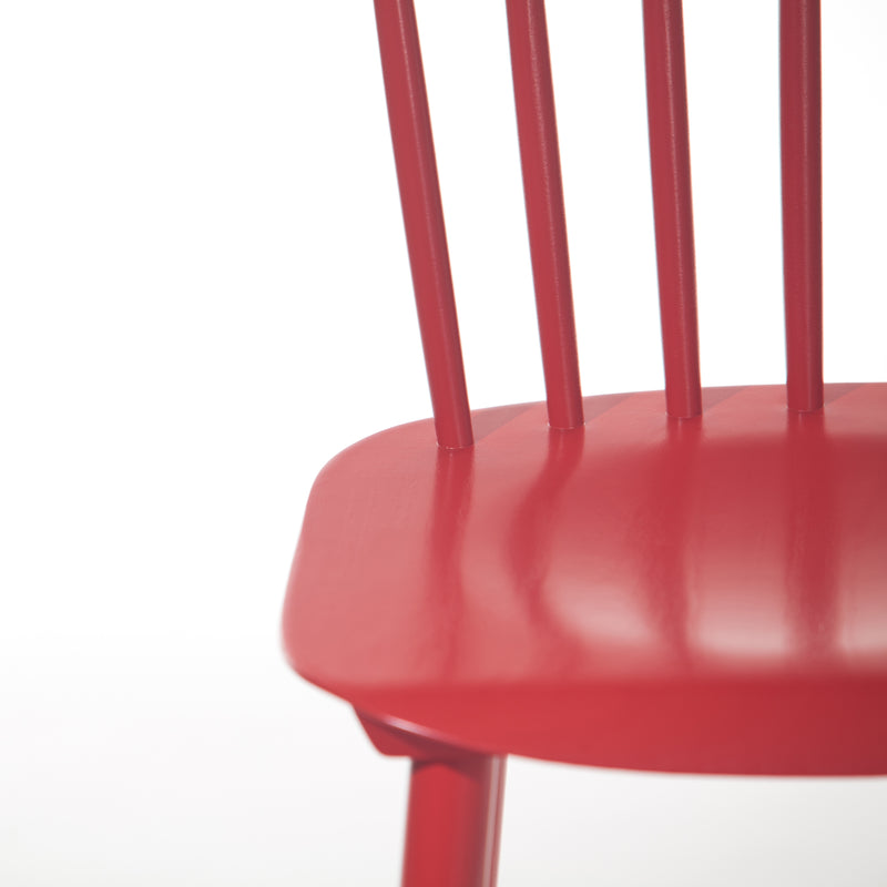 Close-up of a red TON Chair Ironica with a smooth seat and vertical backrest slats, made of beech for a classic retro style, set against a plain white background.