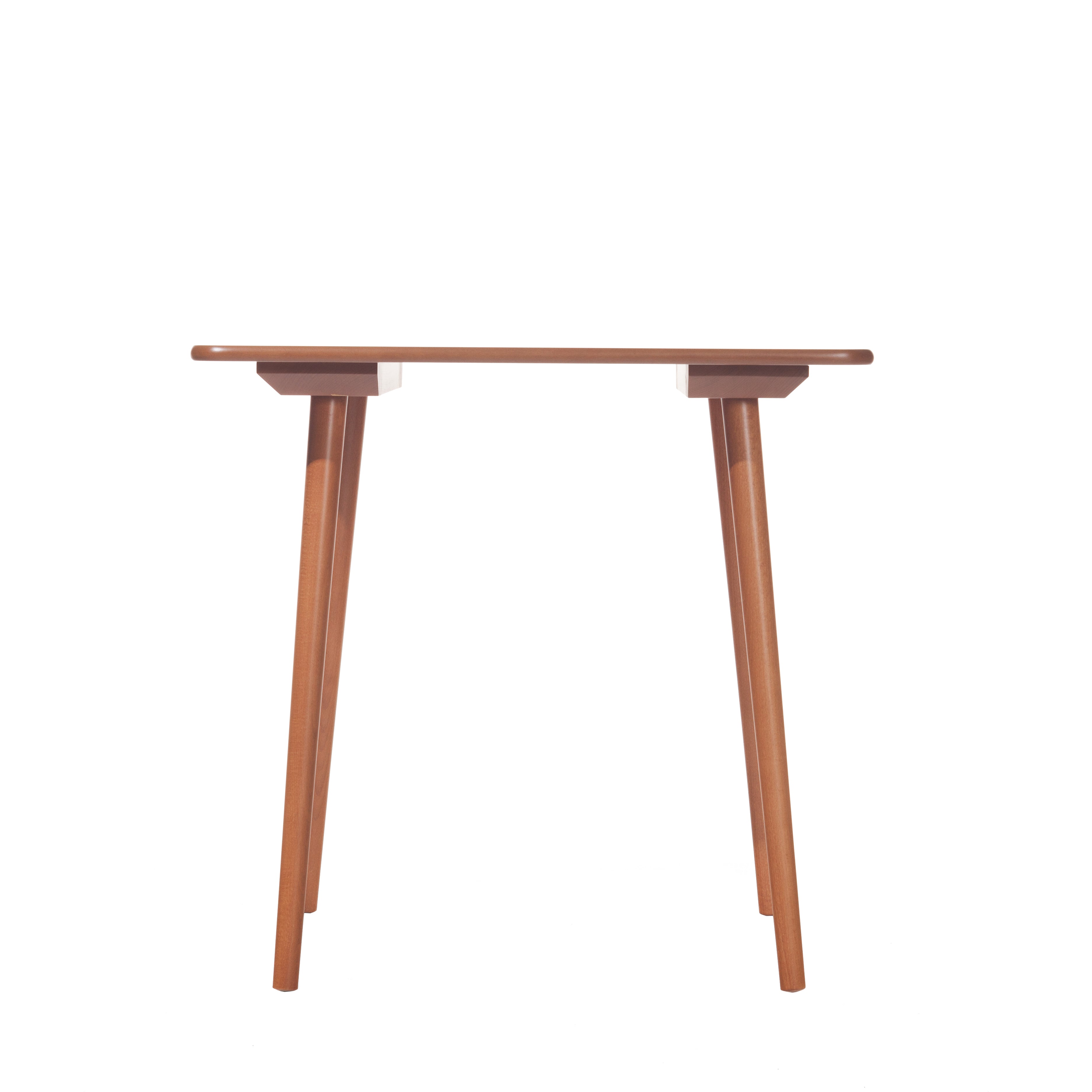 The Table Ironica by TON is a minimalist wooden table crafted from solid beech, featuring four slender legs and a rectangular tabletop that exudes a simple retro style design, viewed from the front against a white background.