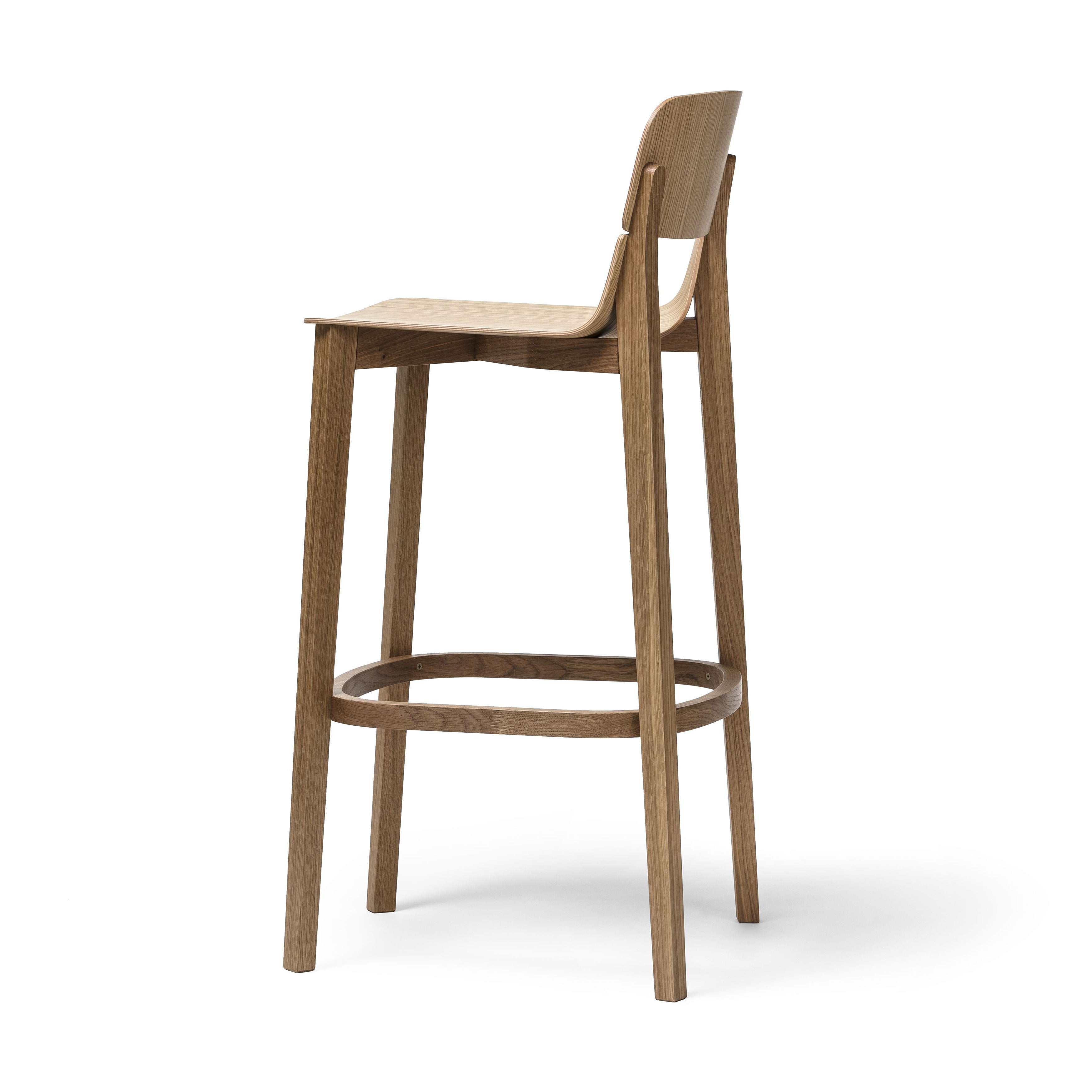 The Barstool Leaf with Backrest by TON features a natural wooden finish and ergonomic design, including a curved backrest and round footrest. Its minimalist style, with four slender legs for support, is essential for any barstool collection.