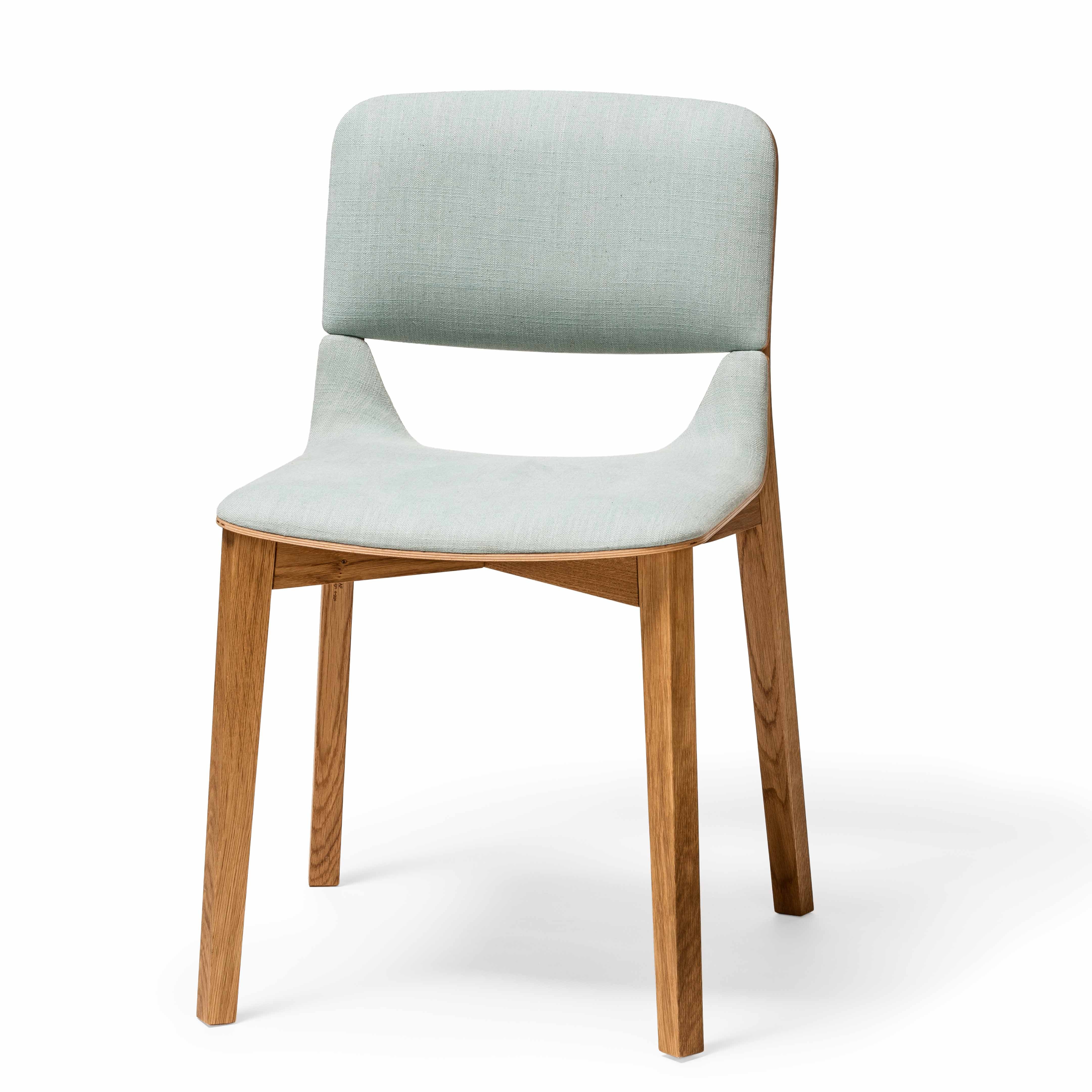 The Chair Leaf - Upholstered by TON features a light blue upholstered seat and backrest, complemented by a light wood frame and legs from the Leaf collection. Its minimalist design is both stylish and ergonomic, ensuring comfort.