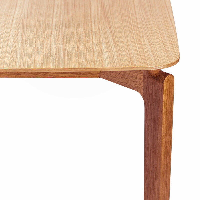 Close-up of the Leaf Table by TON, featuring a light oak finish and smooth, rounded edges. Its solid wood design highlights minimalist, modern craftsmanship with ergonomic features ideal for any space.