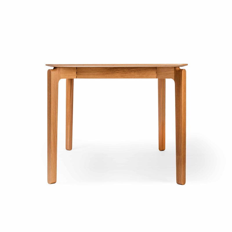 The Leaf Table by TON is a minimalist wooden table featuring a rectangular top and four straight legs. Made from solid wood with a natural finish, it showcases a smooth texture and modern style, perfectly complementing the Leaf collection.