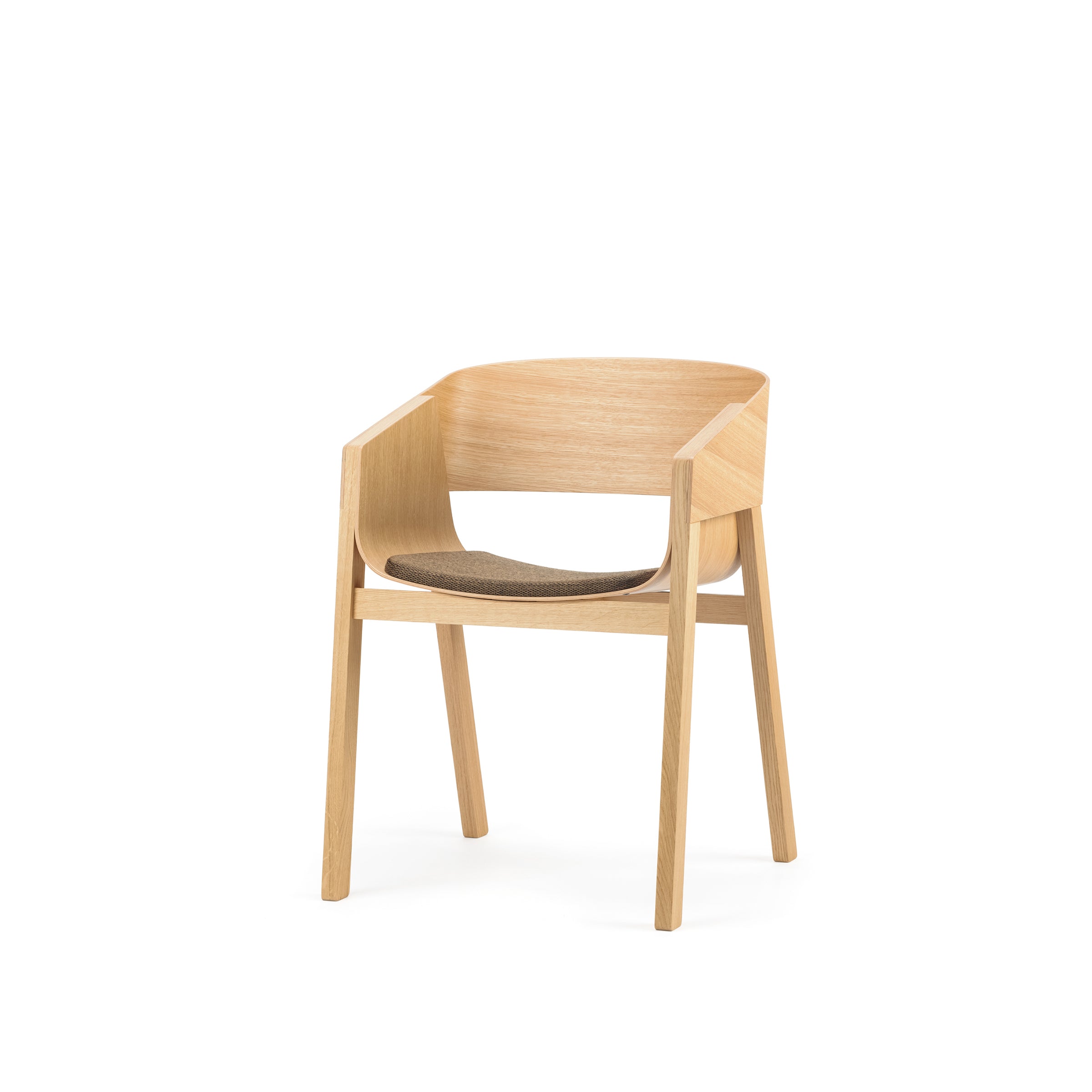 The Armchair Merano by TON combines a solid wood frame with minimalist design elements, featuring straight legs, a curved backrest, and a fabric cushion. Its natural wood finish lends it a modern and elegant look.