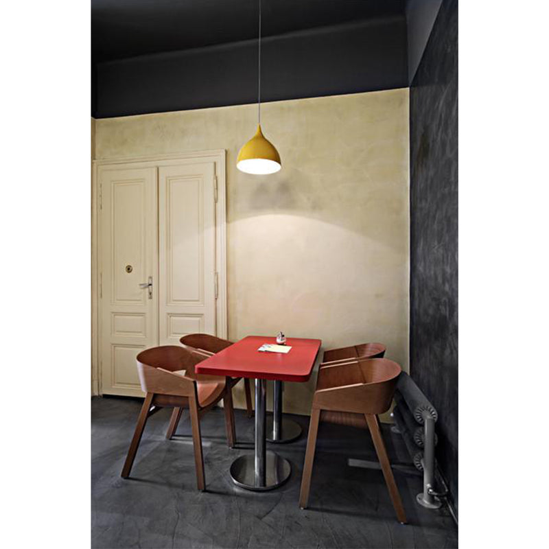 A minimalist room with a small red table and three TON Armchair Merano chairs featuring plywood shells. An orange pendant lamp lights the table. Beige and dark grey walls complement the closed beige door in a solid wood frame.