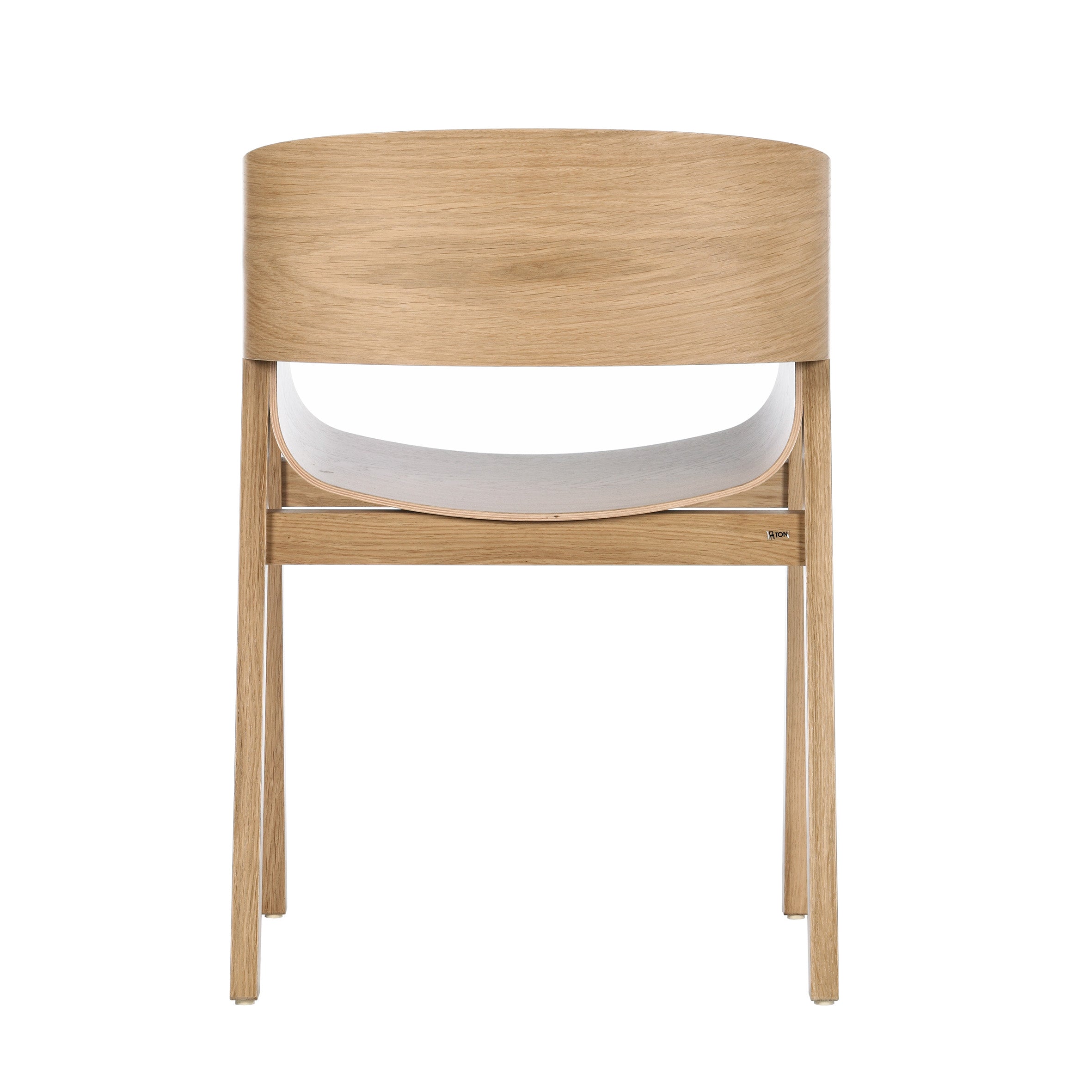 The Armchair Merano by TON is a modern minimalist piece with slender legs, a curved backrest, and a contrasting white seat against its light wood finish. Made with plywood shells and a solid wood frame, it ensures lasting elegance.