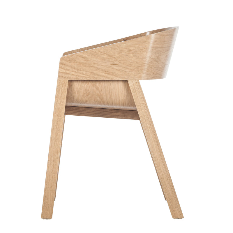Side view of the TON Armchair Merano, a modern minimalist wooden chair with a solid wood frame. It has a smooth, curved backrest and angled legs, displaying a natural finish akin to the TON Designer Armchair.