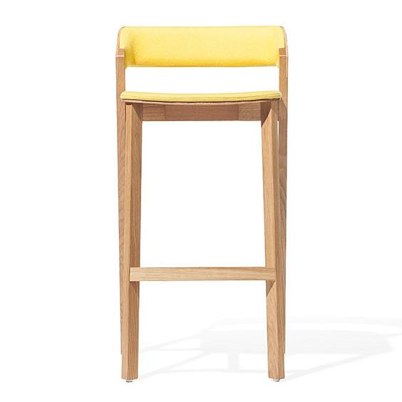 The Barstool Merano by TON features a minimalist design with a solid wood frame and bright yellow upholstered seat and backrest. It has four straight legs connected by horizontal supports, creating an elegant floor shadow.