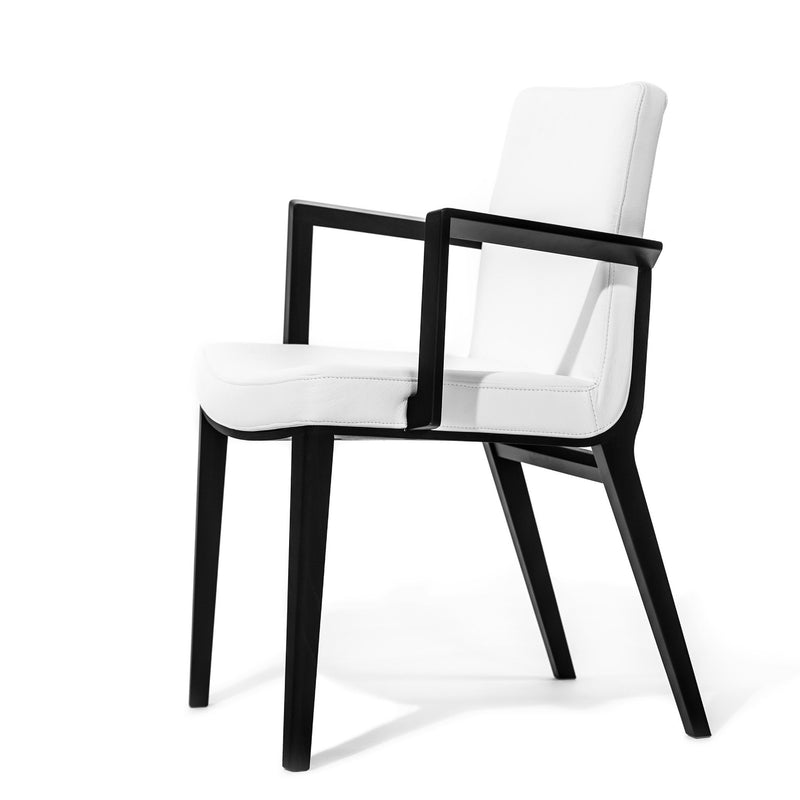The Armchair Moritz by TON is a modern piece with a sleek design, featuring a black wooden frame and white cushioned seat and backrest. Its angled legs and open rectangular armrests contribute to its minimalist elegance, reflecting the sophistication of premium products.