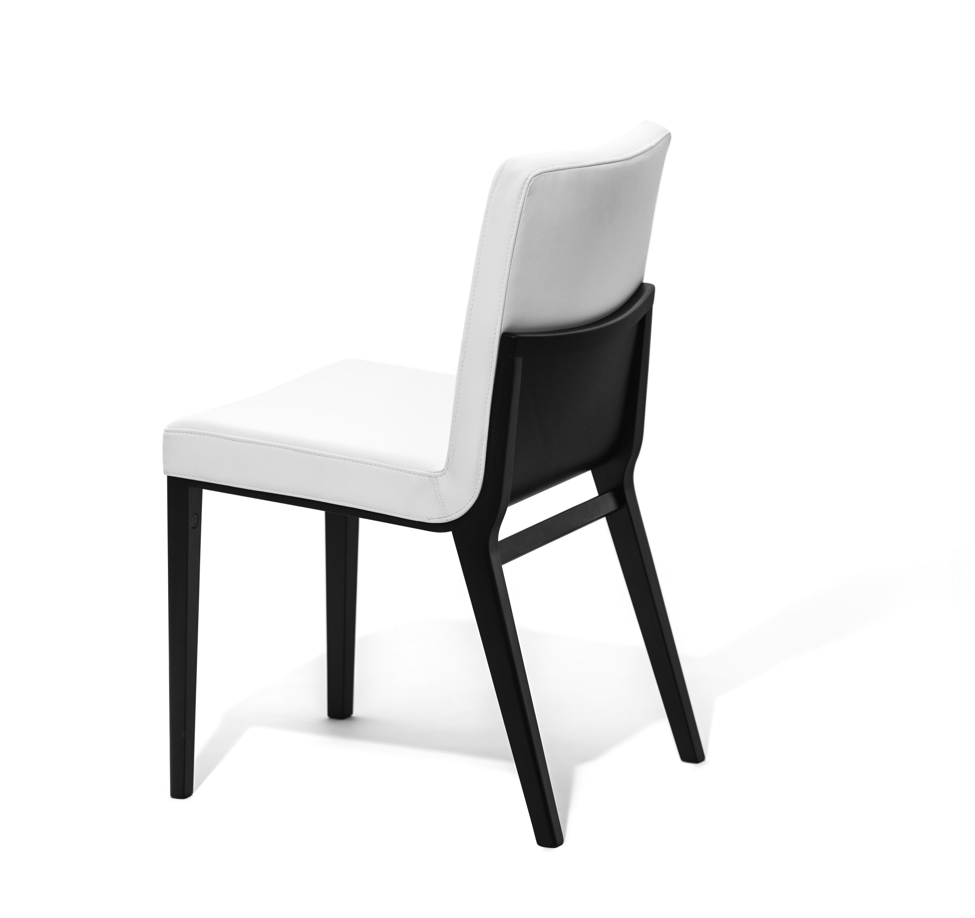 The Chair Moritz by TON, crafted by acclaimed TONDesigner, features a white cushioned seat and backrest on sleek black legs. Positioned at an angle to showcase its side and back, this minimalist design exemplifies the comfort and contemporary aesthetic of premium products.